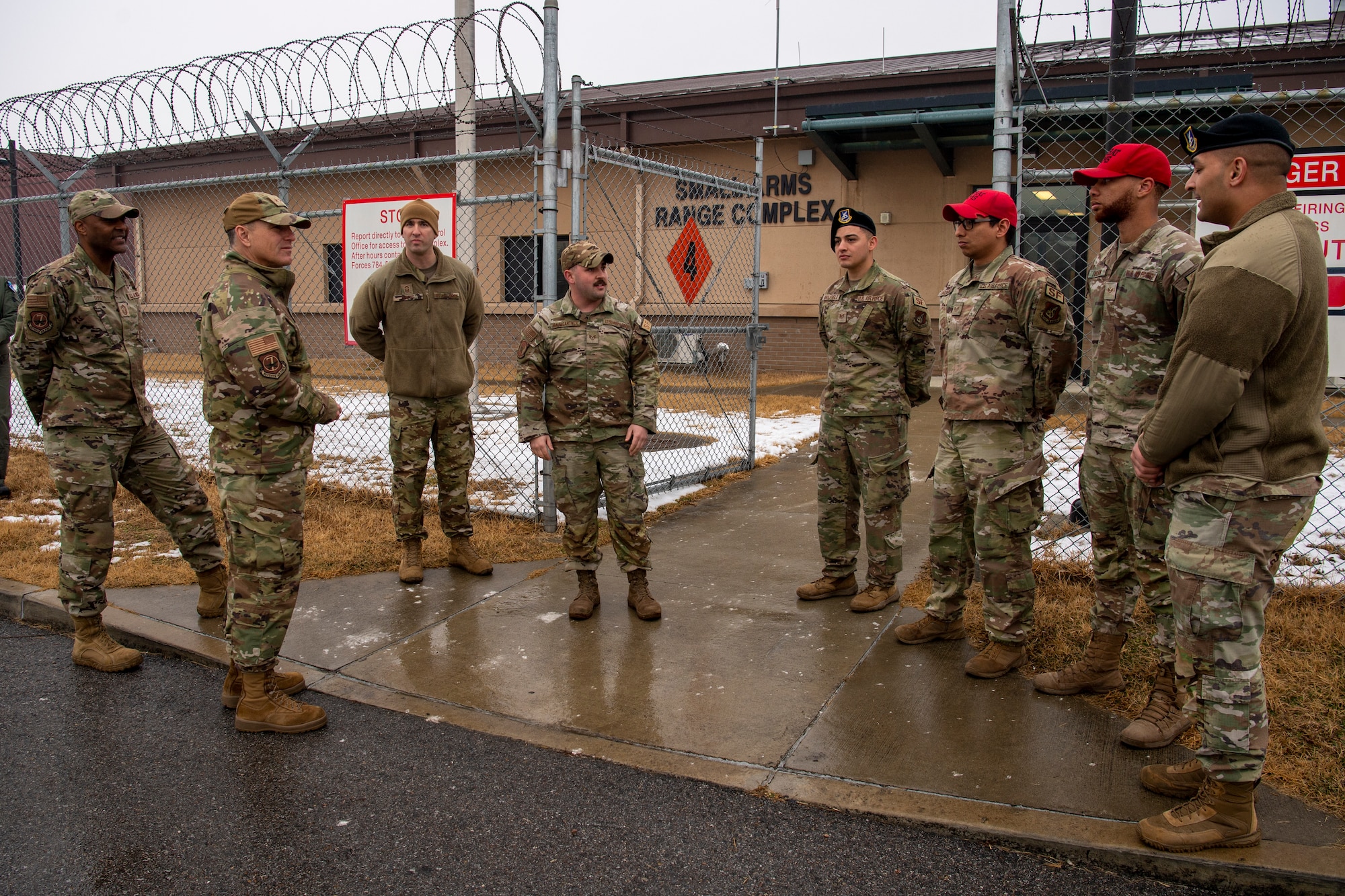 U.S. Air Force Lt. Gen. Scott Pleus (middle-left), 7th Air Force commander and U.S. Air Force Chief Master Sgt. Alvin Dyer (far-left), 7th AF command chief, speak to members of the 51st Security Forces Squadron Combat Arms Training and Maintenance (CATM) flight, Dec. 21, 2022, at Osan Air Base, Republic of Korea.