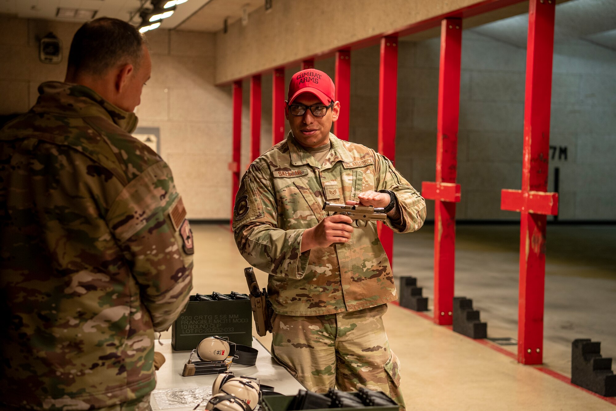 U.S. Air Force Staff Sgt. Anthony Salazar (right), 51st Security Forces Squadron assistant NCO in charge of Combat Arms Training and Maintenance (CATM), gives a safety brief about the M-18 pistol to U.S. Air Force Lt. Gen. Scott Pleus (left), 7th Air Force commander in the 51st SFS CATM firing range, Dec. 21, 2022, at Osan Air Base, Republic of Korea