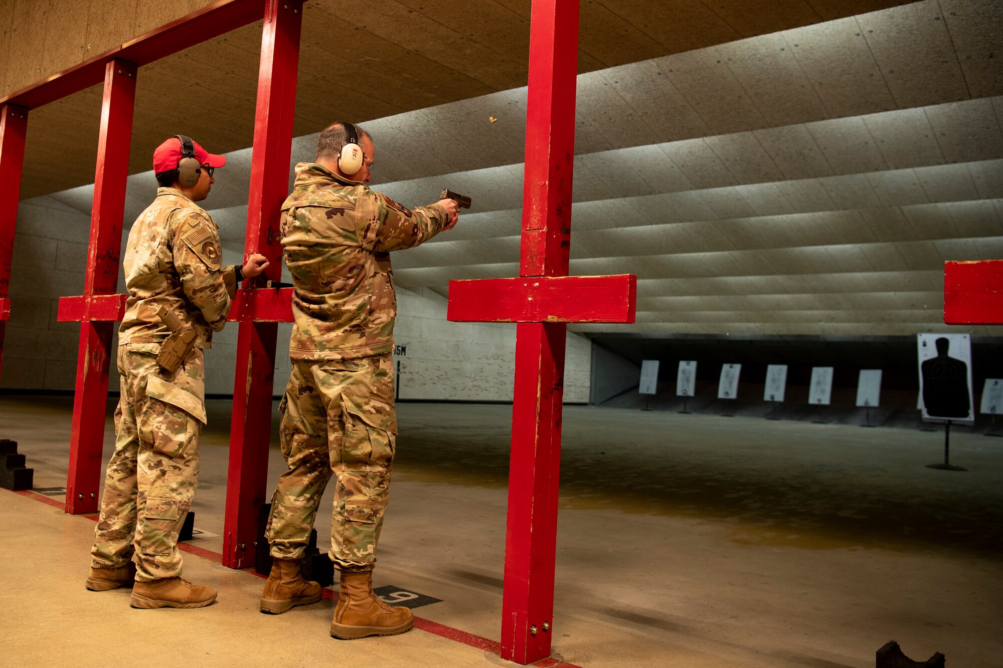 U.S. Air Force Lt. Gen. Scott Pleus (right), 7th Air Force commander fires the M-18 pistol in the 51st Security Forces Squadron Combat Arms Training and Maintenance (CATM) firing range, Dec. 21, 2022, at Osan Air Base, Republic of Korea.