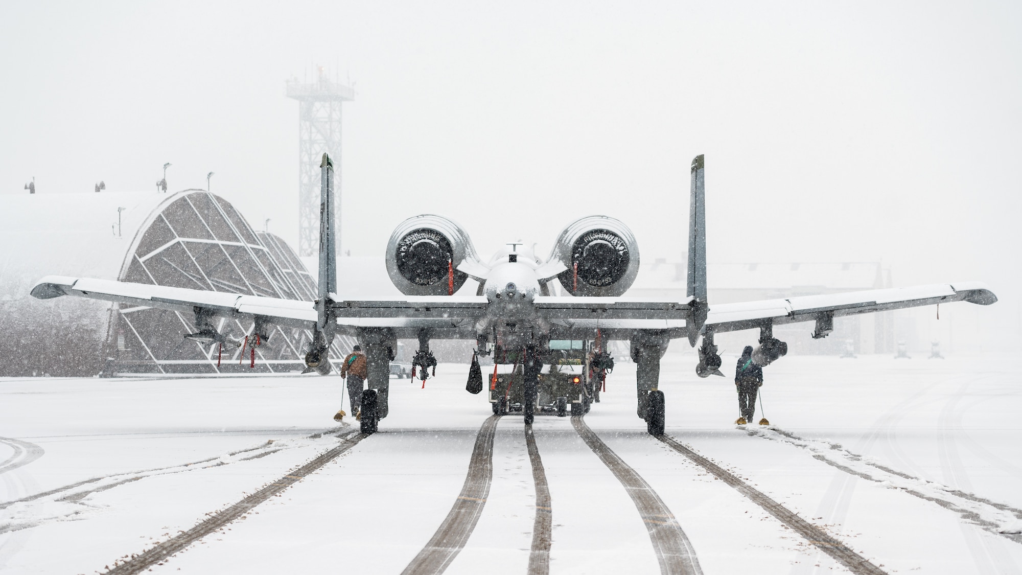 25th Fighter Generation Squadron crew chiefs relocate an A-10C Thunderbolt II from the flightline into a hangar during an FGS training event