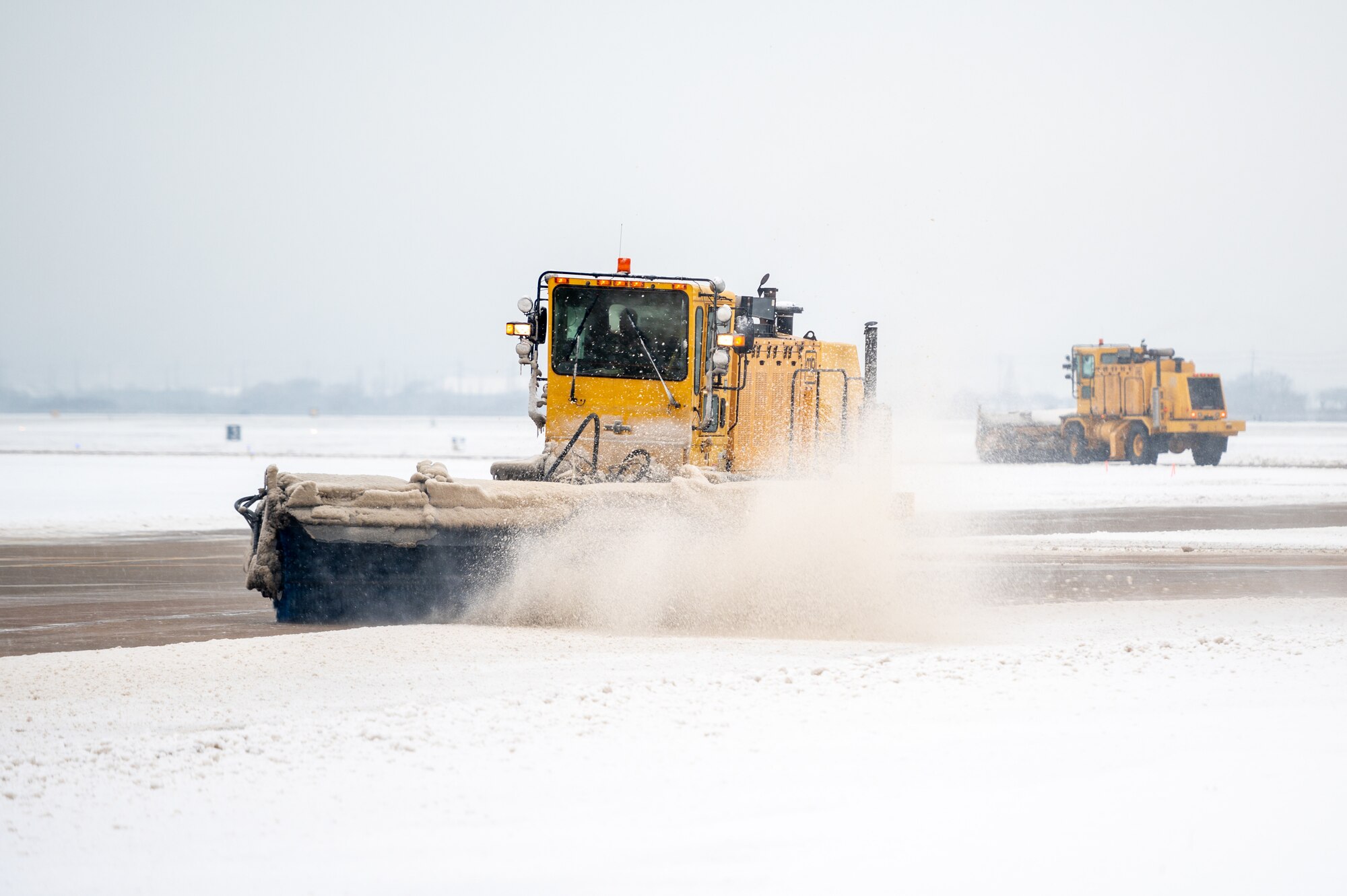 Airmen assigned to the 51st Civil Engineer Squadron clear snow from the flightline at Osan Air Base, Republic of Korea, Dec. 15, 2022.