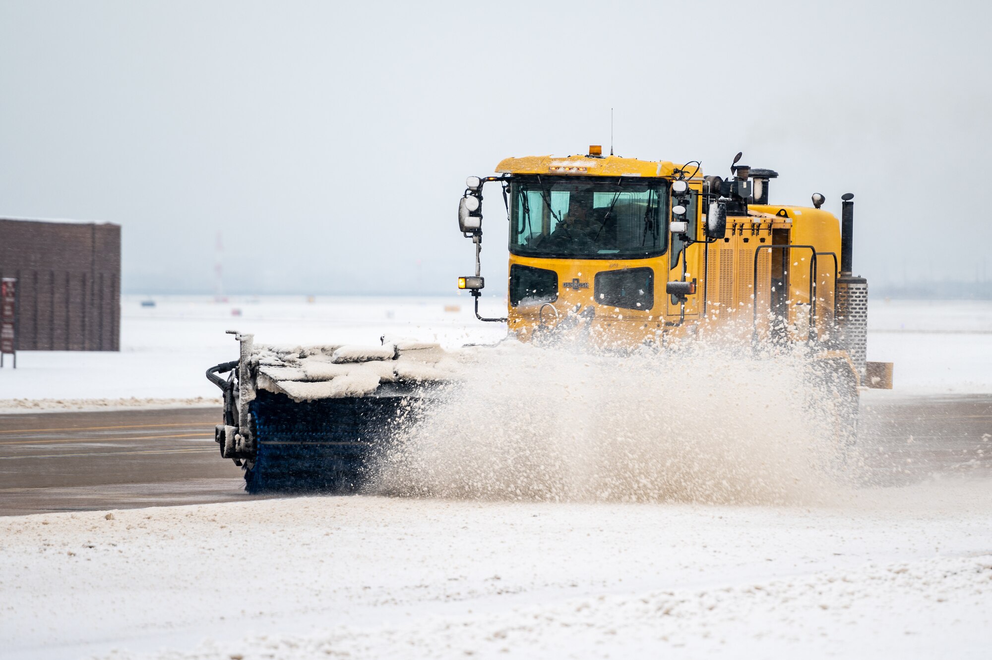 A 51st Civil Engineer Squadron Airman clears snow from a taxiway at Osan Air Base, Republic of Korea, Dec. 15, 2022.