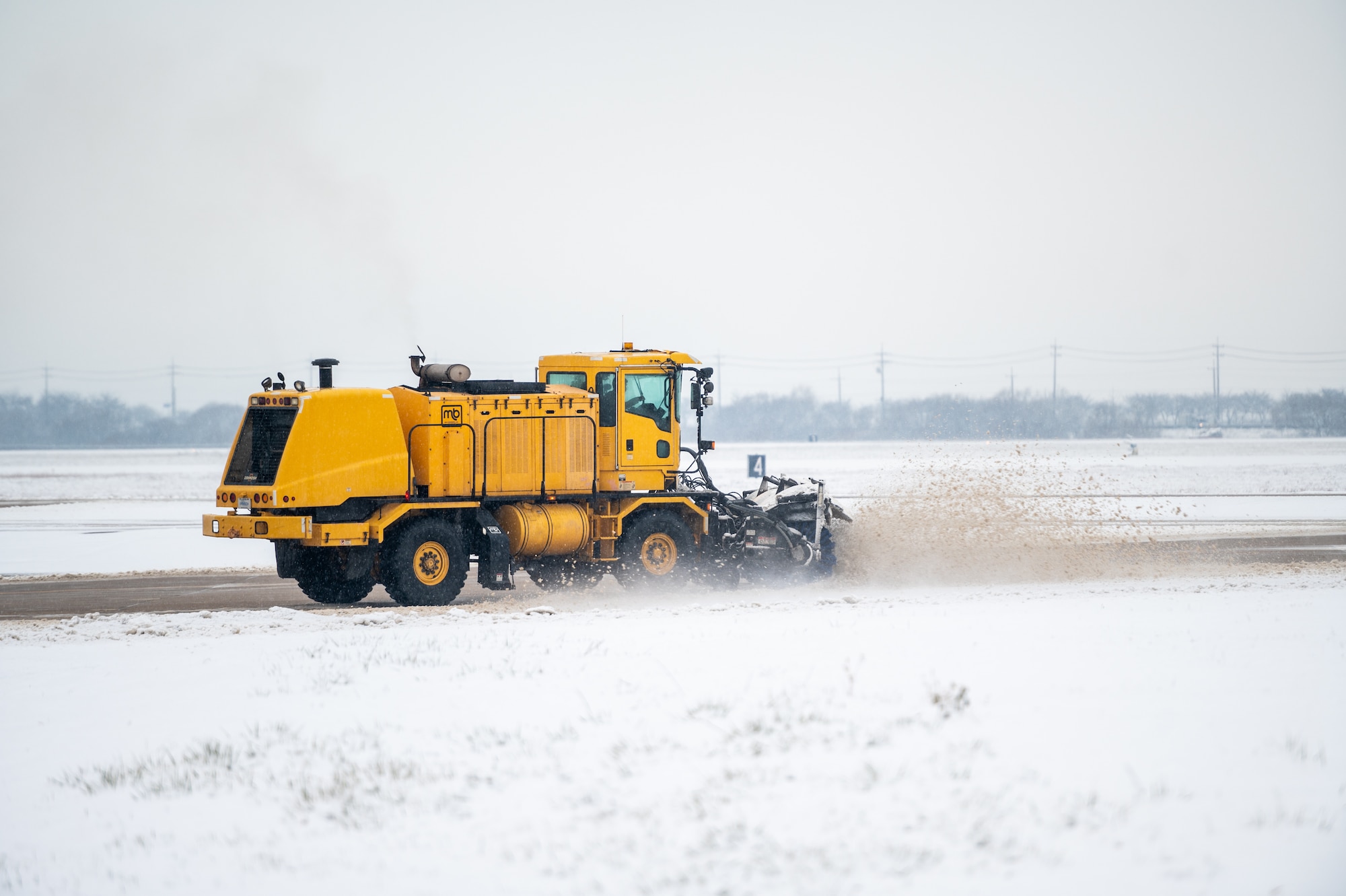 A 51st Civil Engineer Squadron Airman clears snow from a taxiway at Osan Air Base, Republic of Korea, Dec. 15, 2022.