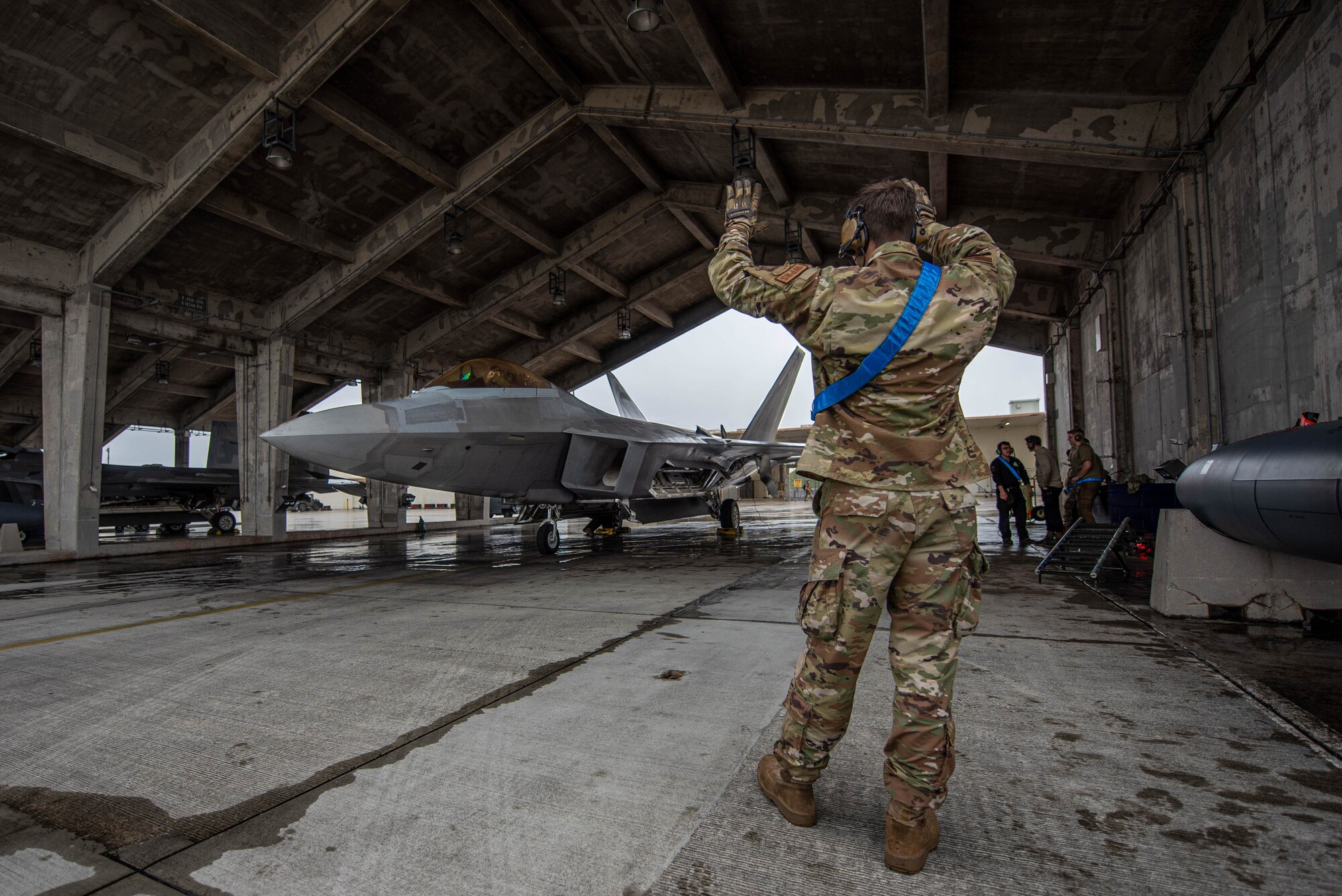 An Airman uses hand signals to communicate.