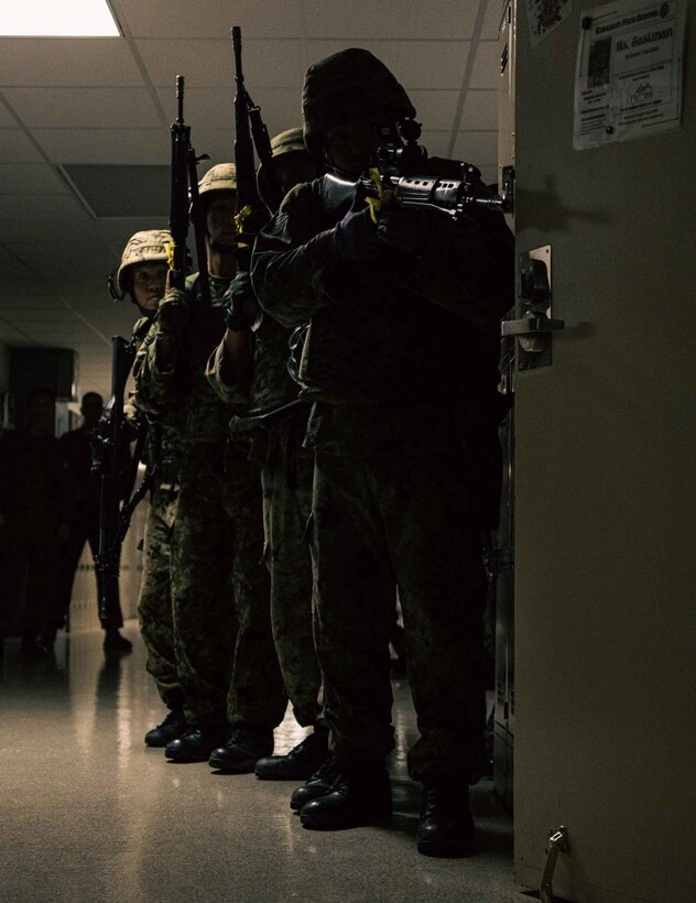 Members with Japan Ground Self-Defense Force, 51st Infantry Regiment, prepare to breach a room during a simulated bilateral search while participating in Exercise Keen Sword 2023 on Camp Foster, Okinawa, Japan, Nov. 13, 2022. Keen Sword exercises the combined command and control capabilities and lethality developed between Marine Corps Installations Pacific, III Marine Expeditionary Force, and the Japan Self-Defense Force. This bilateral field-training demonstrates the U.S. military and JSDF interoperability and combat readiness of the U.S.-Japan Alliance. (U.S. Marine Corps photo by Lance Cpl. Jonathan Beauchamp)