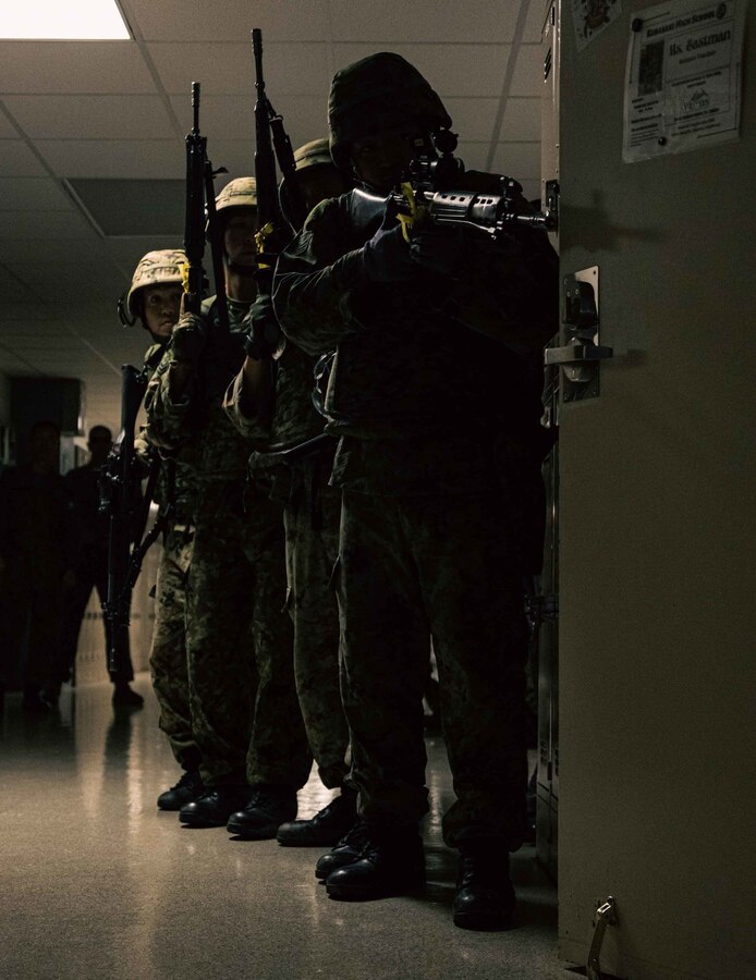 Members with Japan Ground Self-Defense Force, 51st Infantry Regiment, prepare to breach a room during a simulated bilateral search while participating in Exercise Keen Sword 2023 on Camp Foster, Okinawa, Japan, Nov. 13, 2022. Keen Sword exercises the combined command and control capabilities and lethality developed between Marine Corps Installations Pacific, III Marine Expeditionary Force, and the Japan Self-Defense Force. This bilateral field-training demonstrates the U.S. military and JSDF interoperability and combat readiness of the U.S.-Japan Alliance. (U.S. Marine Corps photo by Lance Cpl. Jonathan Beauchamp)