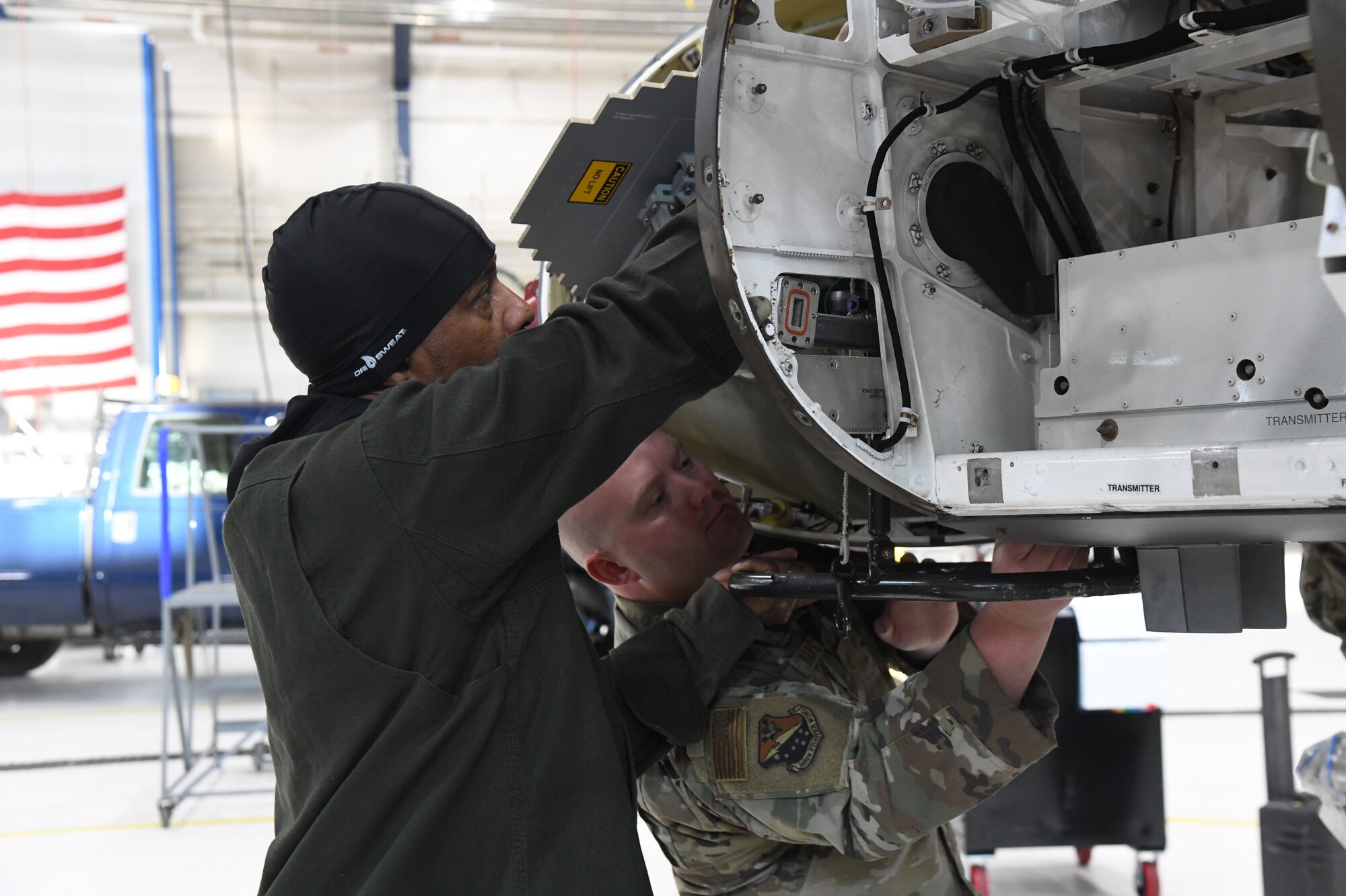 An Aircraft Integrated Avionics technician assigned to the 148th Fighter Wing, Minnesota Air National Guard, and a contractor from Lockheed Martin install the active electronic scanned array (AESA) radar on the Wing's F-16 Fighting Falcons on November 8, 2022 at the Duluth Air National Guard Base, Minnesota.