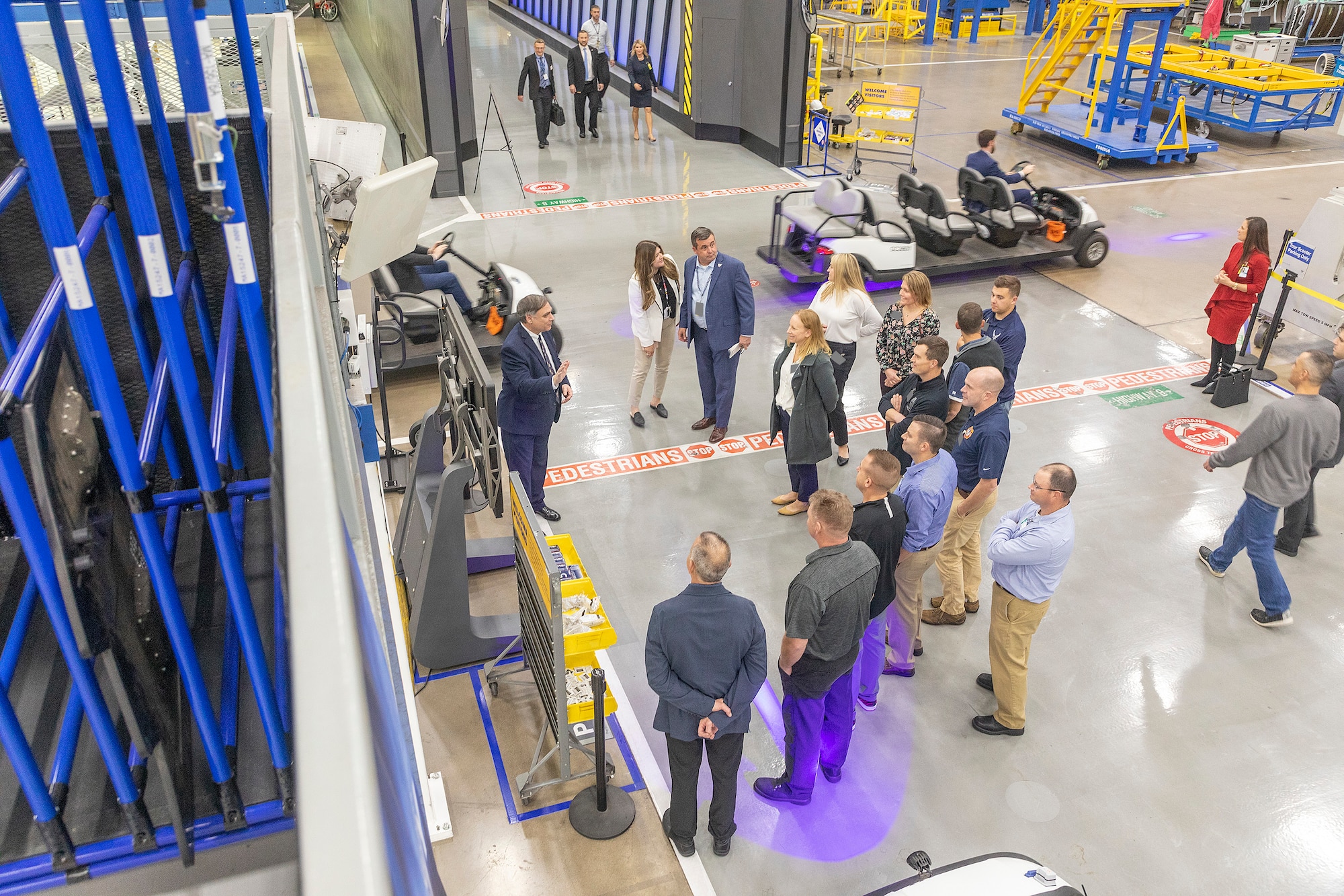 A tour guide provides information to 115th Fighter Wing members during a facility visit at Lockheed Martin