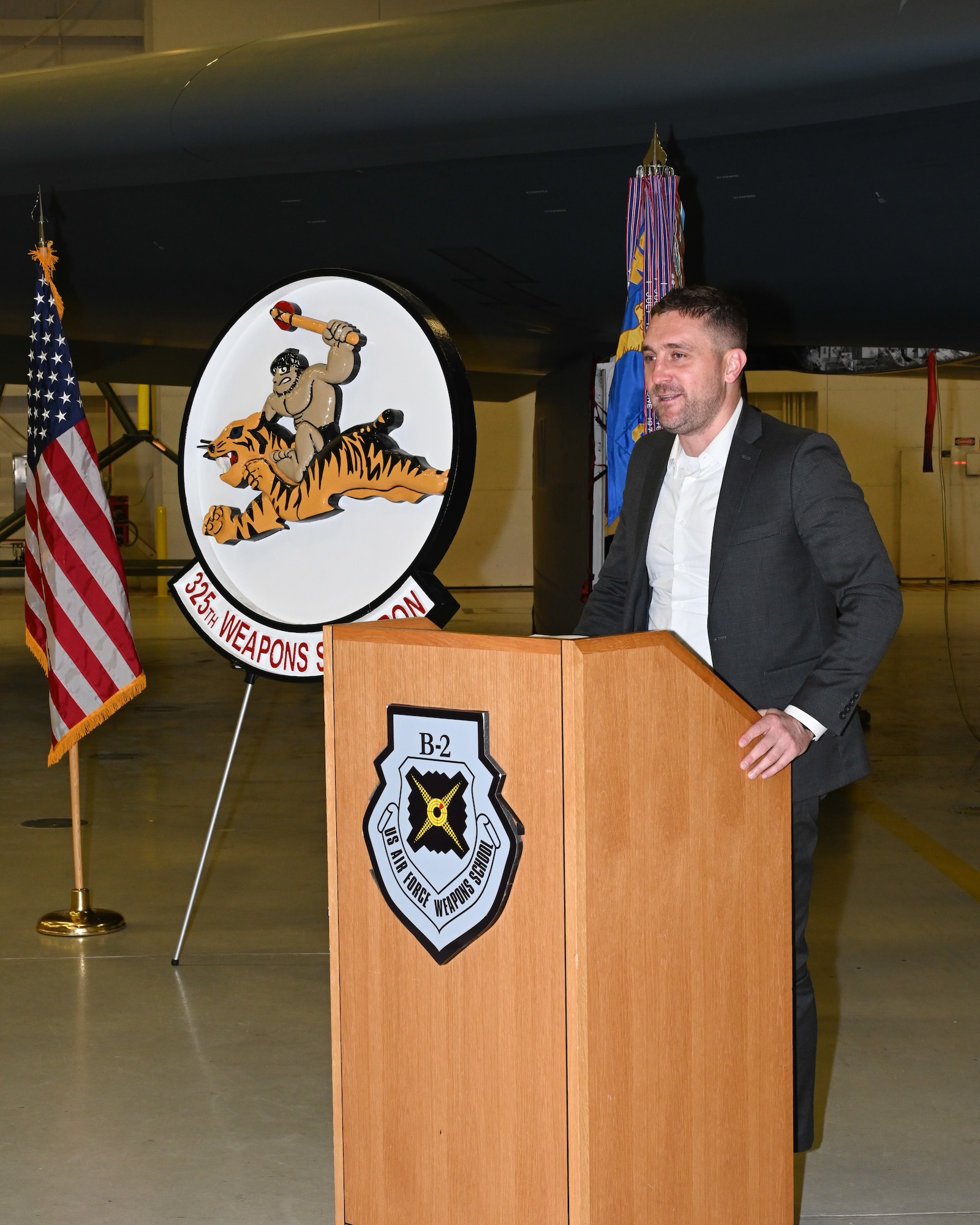 Patrick McGeehan, son of Lt. Col. Mark McGeehan, speaks at an award ceremony at Whiteman Air Force Base, Mo., Dec. 13, 2022. McGeehan talks about his father and the impact he had on his family before his death. (U.S. Air Force photo by Airman 1st Class Nash Truitt)