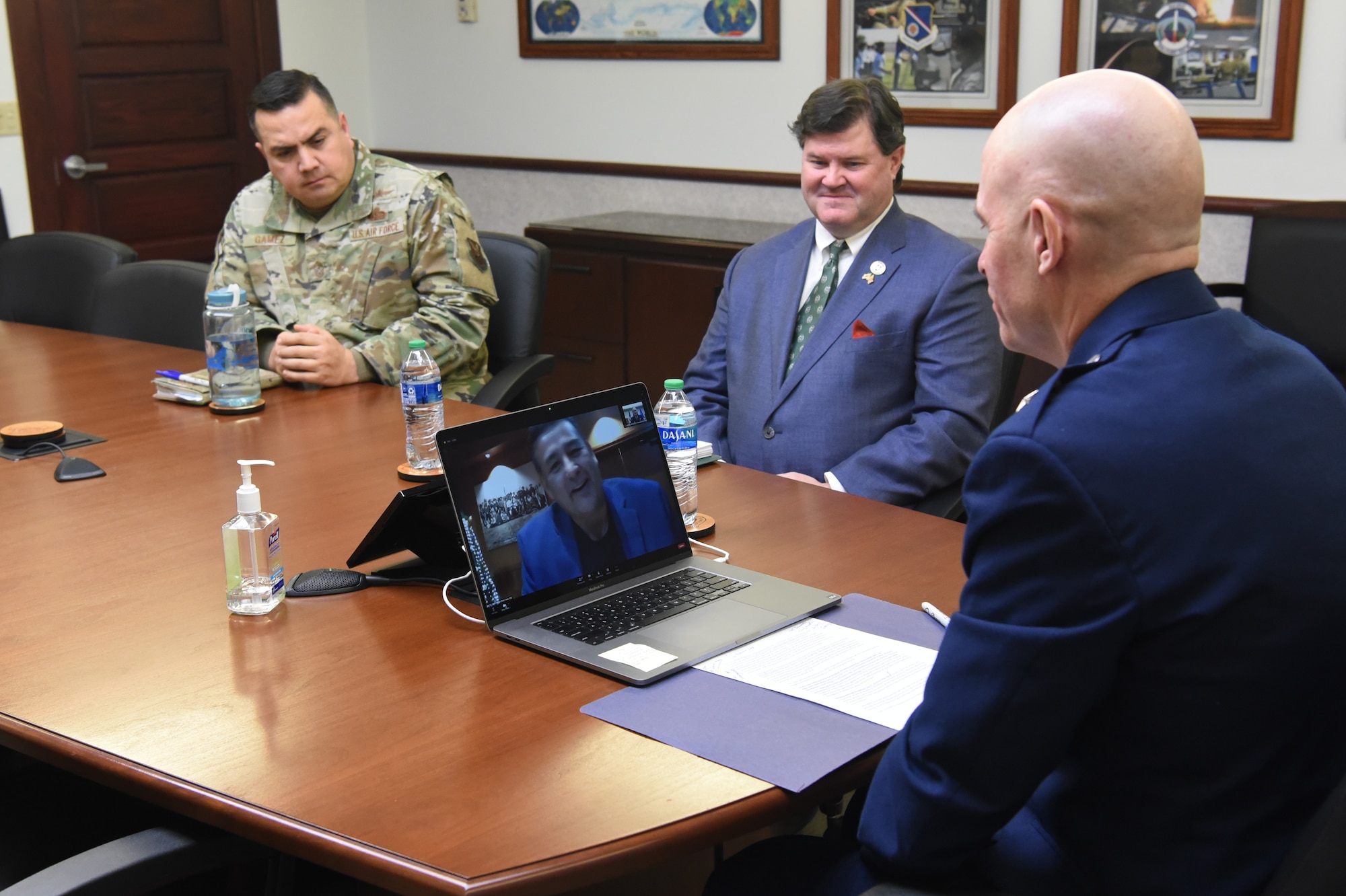 Maj. Gen. Michael Lutton, 20th Air Force commander, right, watches as Mark Fox, chairman of the Mandan, Hidatsa and Arikara Nation, on the computer screen, gives remarks during the Sentinel Programmatic Agreement Signing Ceremony.