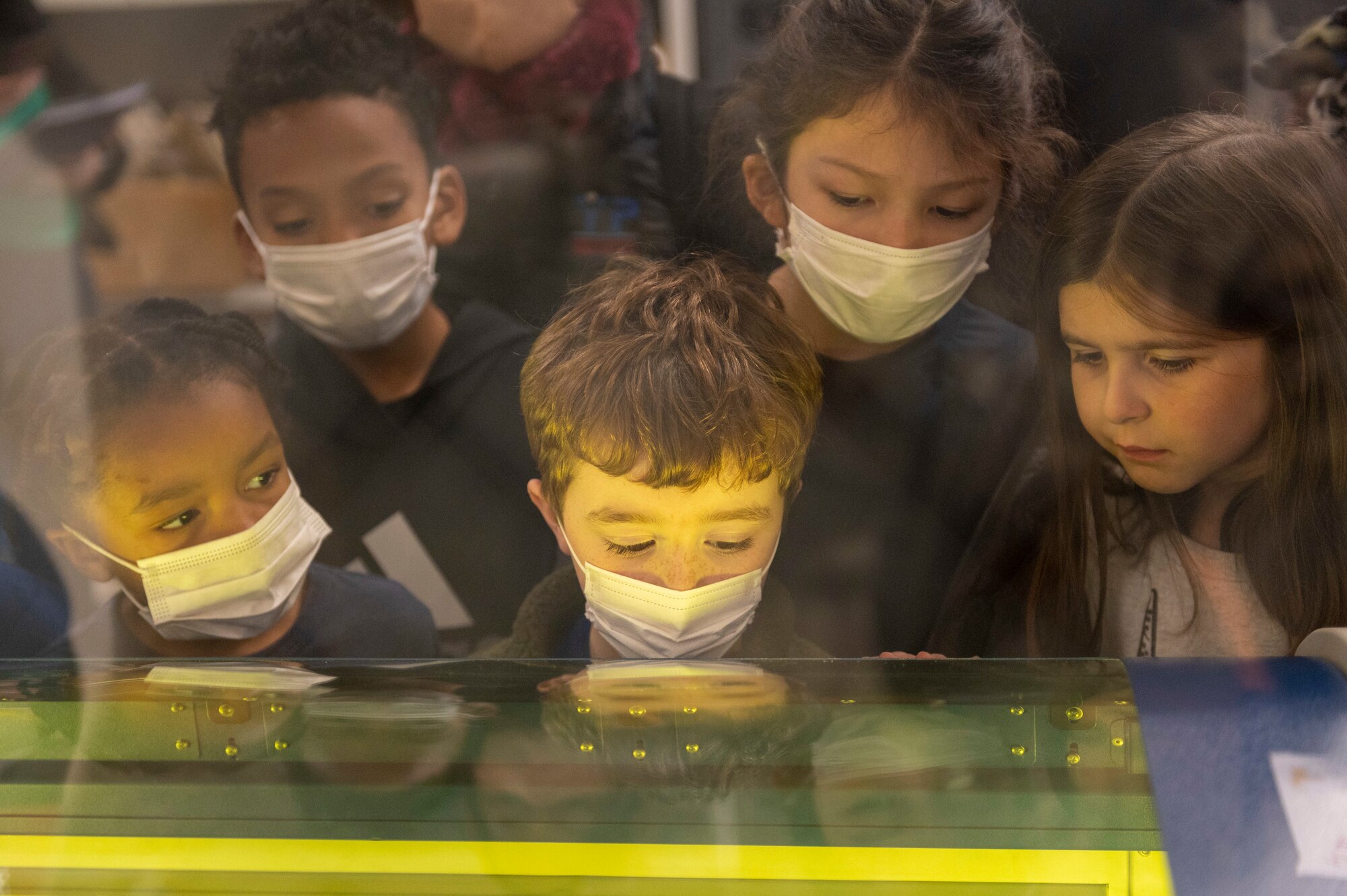 Kids watch a laser etching machine