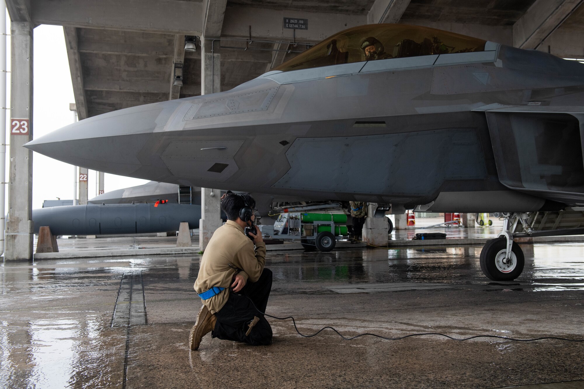 An Airman conducts preflight checks.