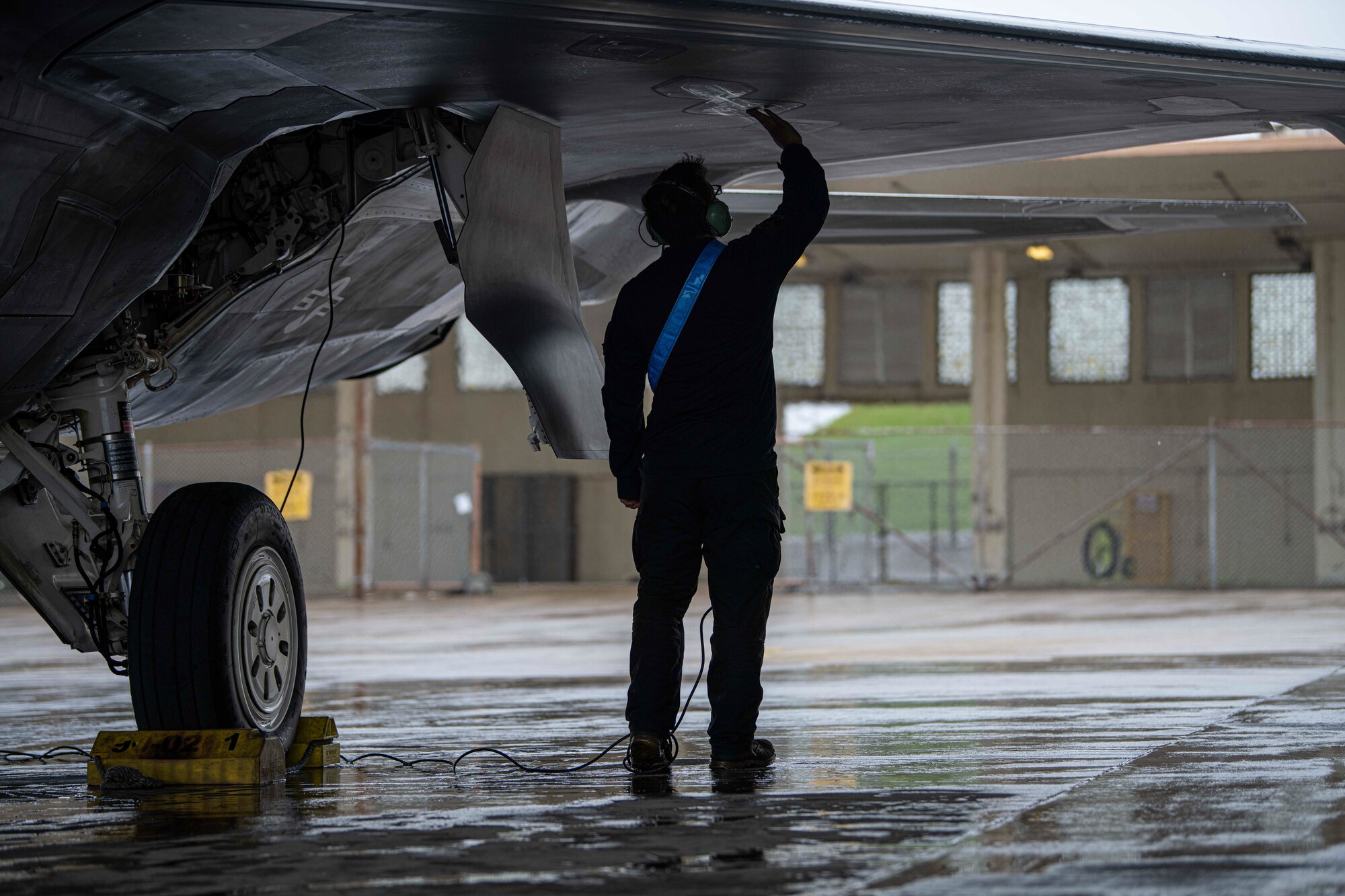 An Airman conducts preflight checks.