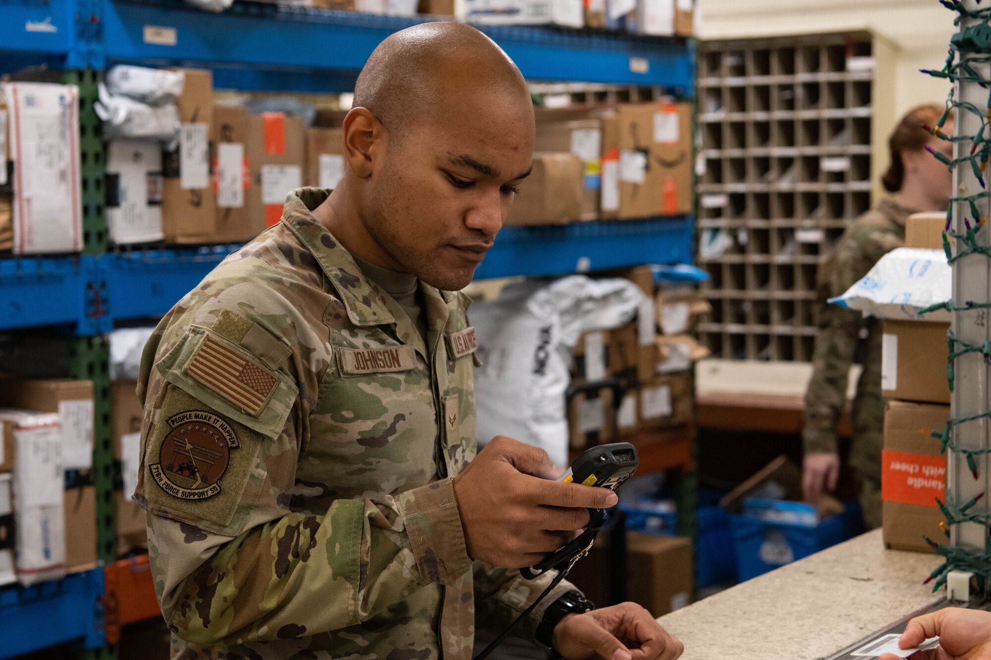 An Airman works a service desk.