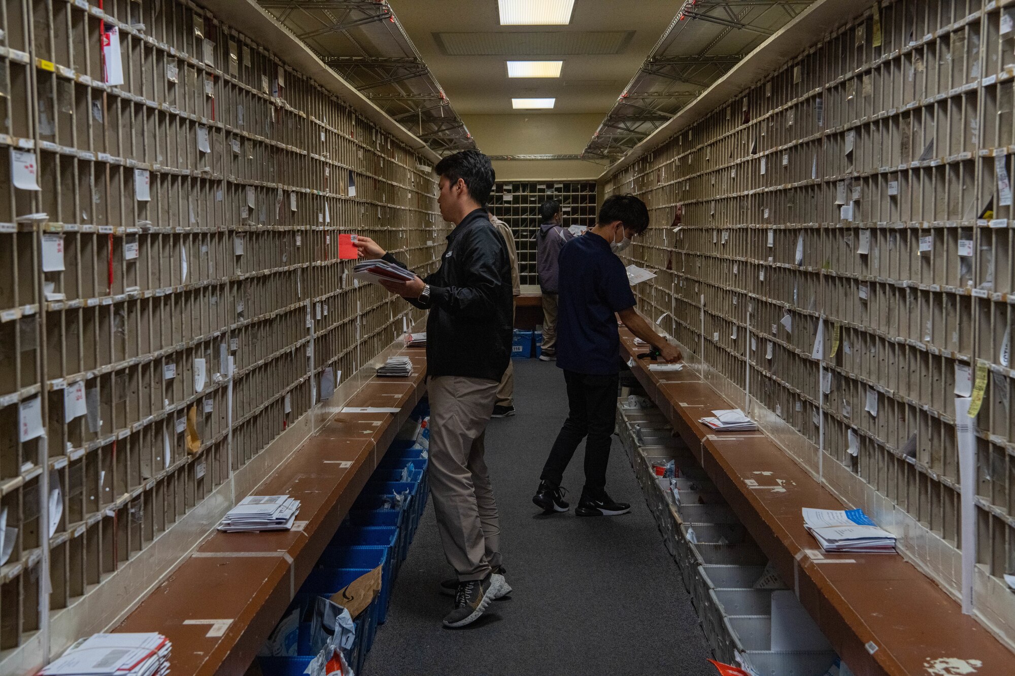 Postal clerks sort mail.