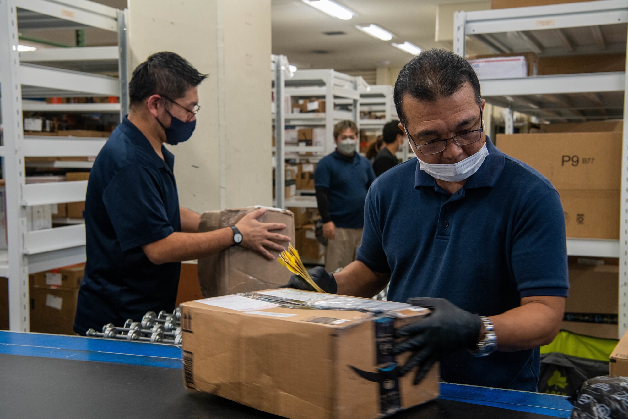 Postal clerks sort mail.