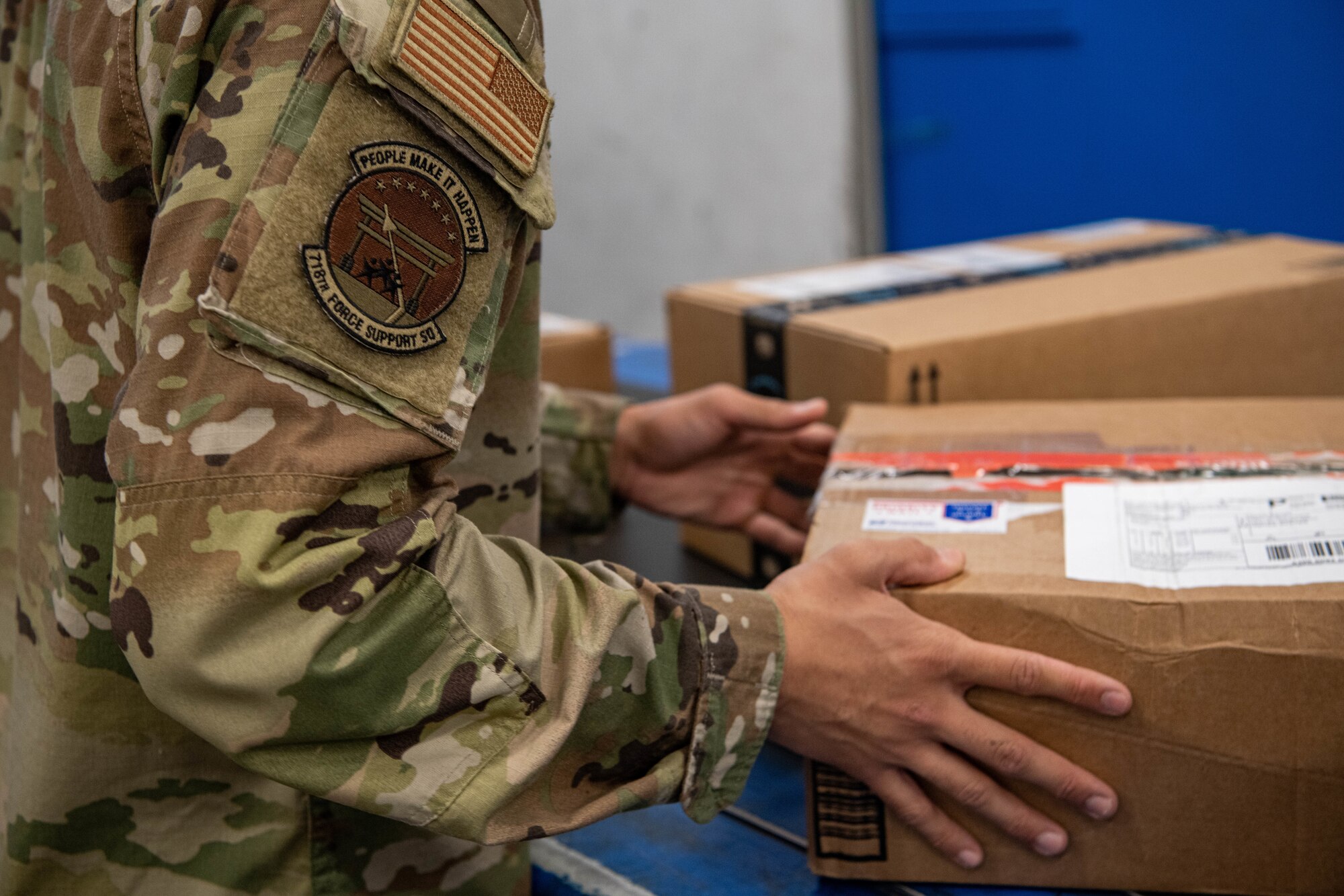 An Airman sorts mail.