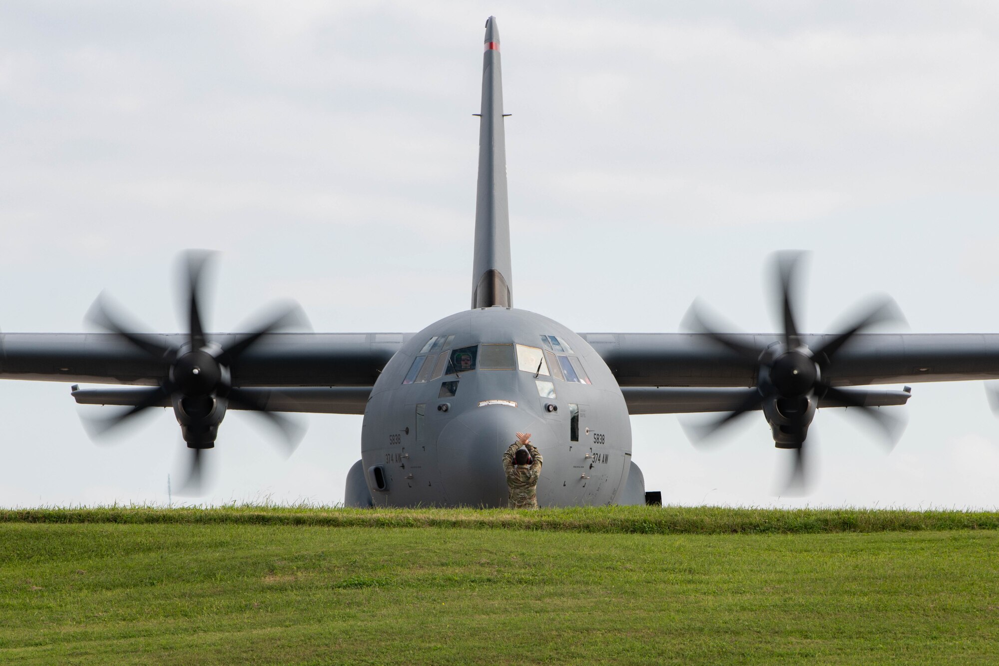 An Airman marshals an aircraft.