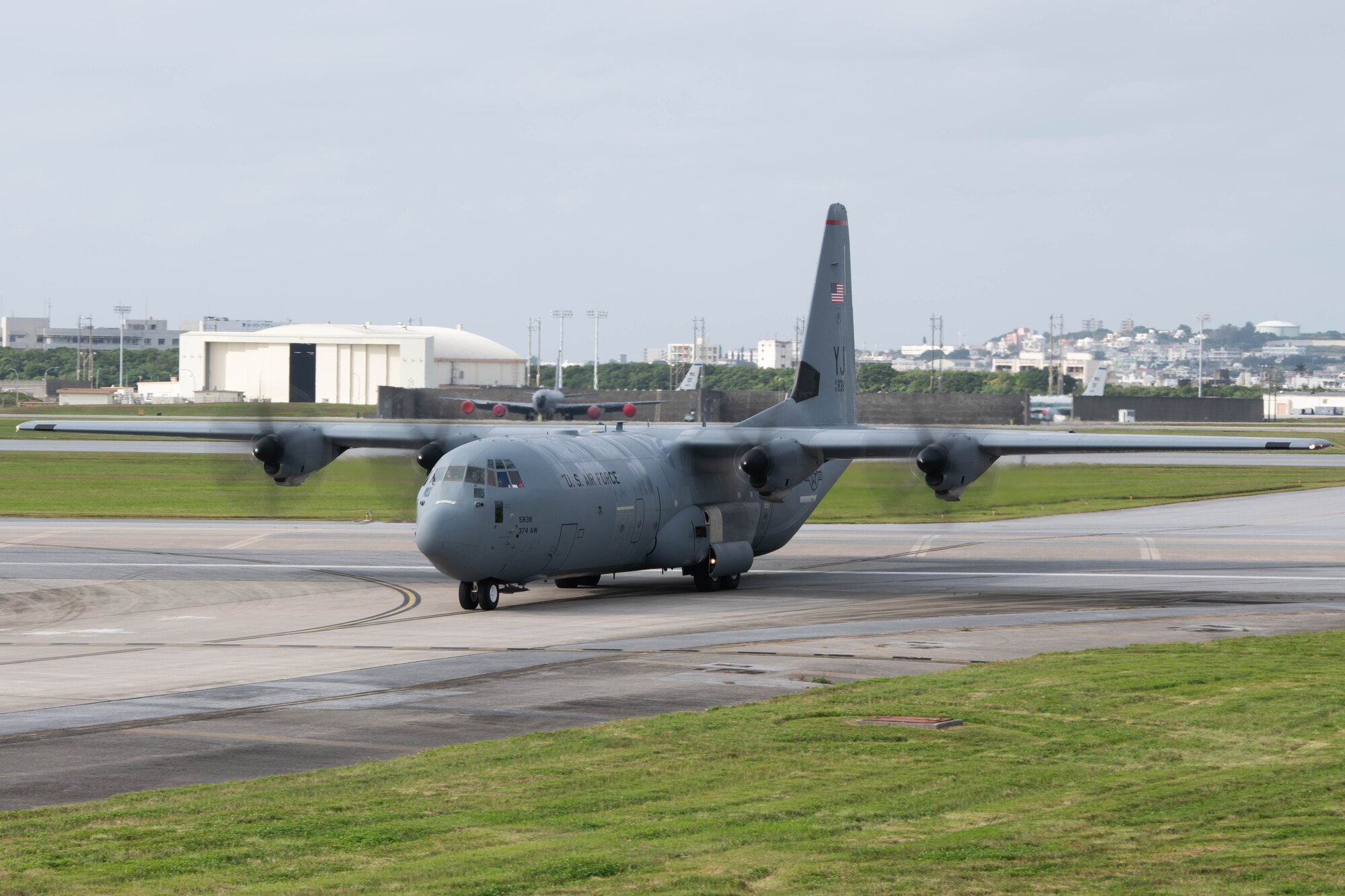 An aircraft taxis across a runway.