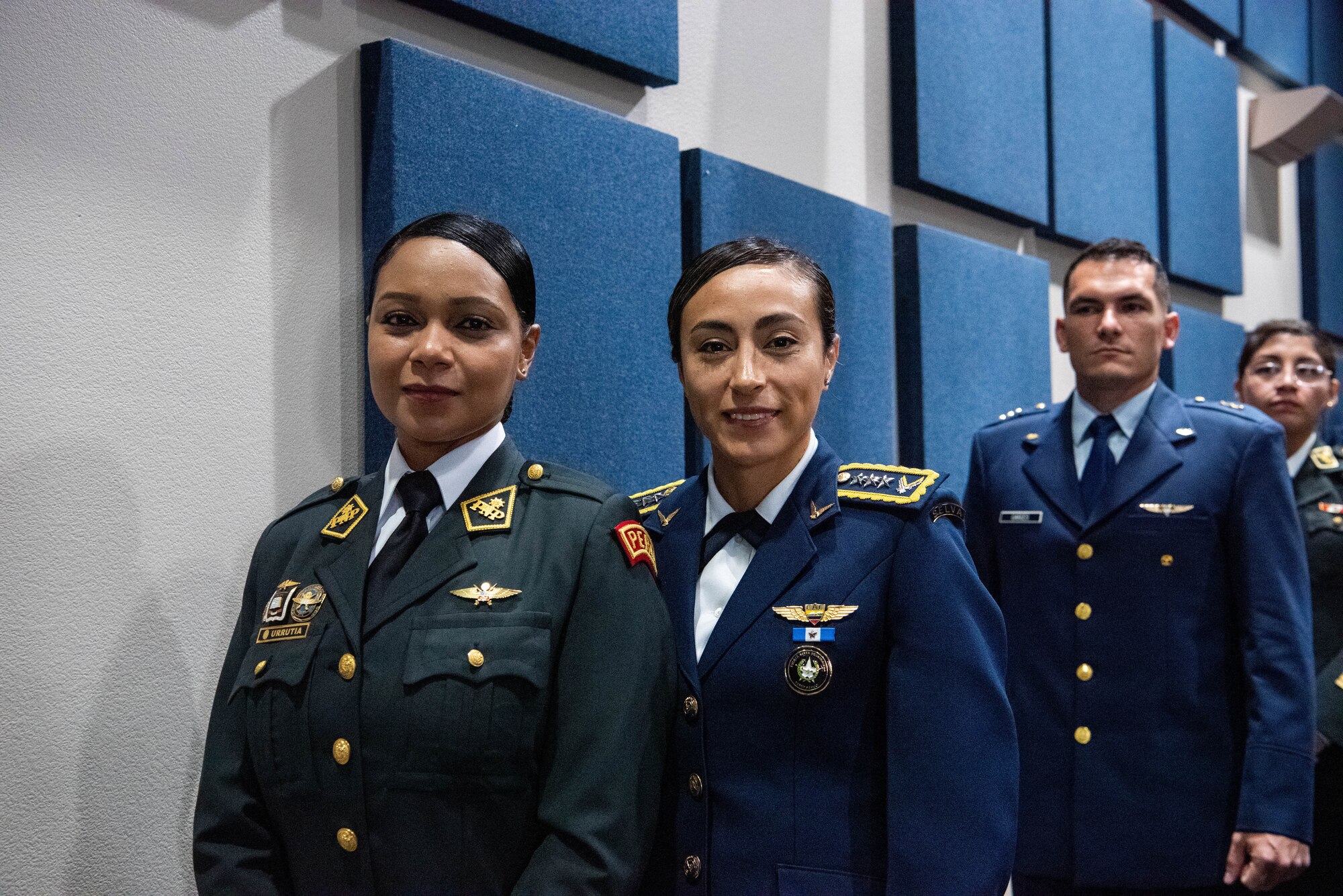 International military students smile before approaching the stage during the Inter-American Air Forces Academy’s graduation ceremony at Joint Base San Antonio-Lackland, Texas, Dec. 7, 2022. More than 150 international military students from 12 partner nations across Latin America and the USAF graduated during the last training cycle of 2022. (U.S. Air Force photo by Vanessa R. Adame)
