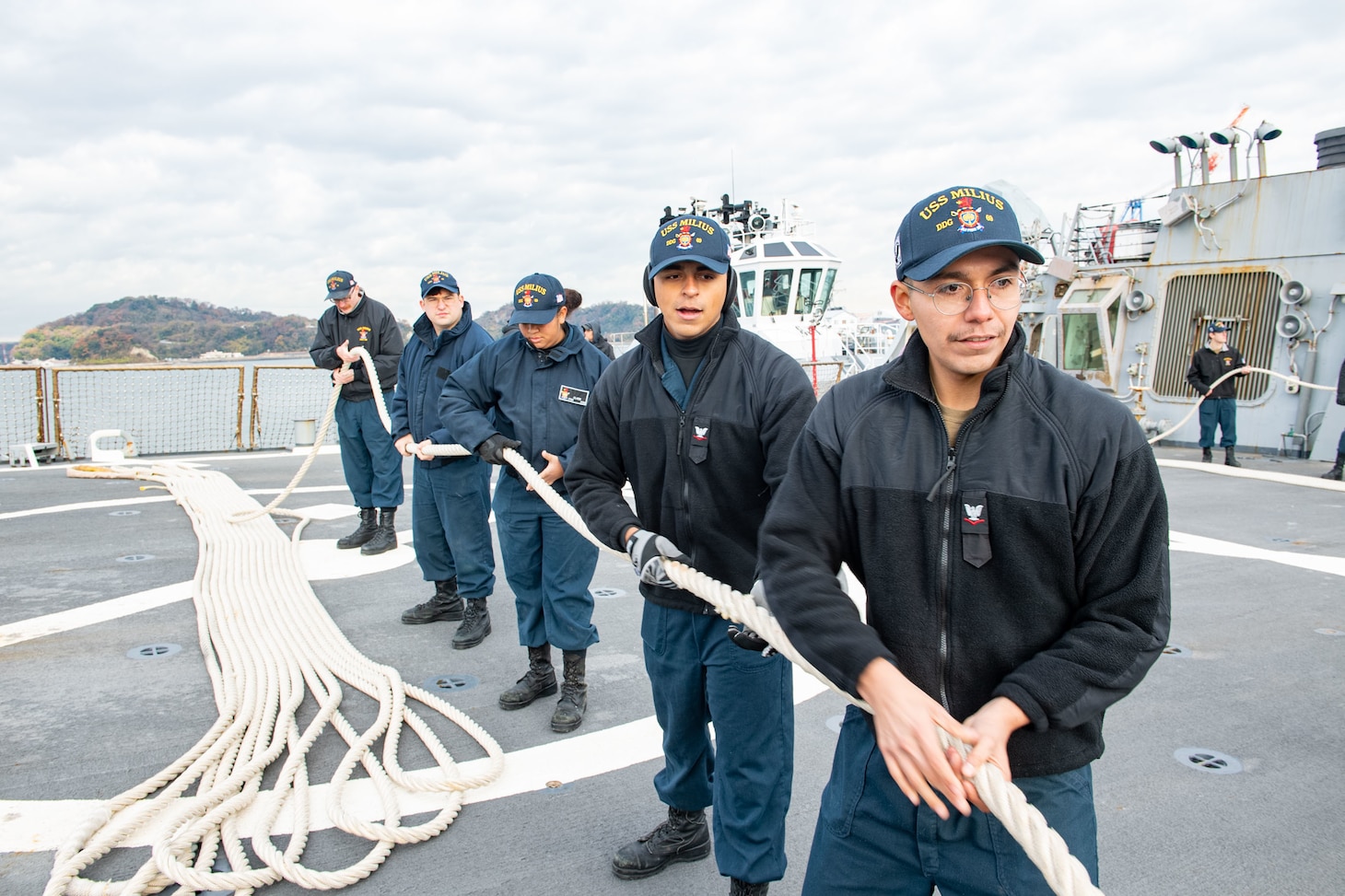 YOKOSUKA, JAPAN (Dec. 21, 2022) Sailors aboard Arleigh Burke-class guided-missile destroyer USS Milius (DDG 69) handle lines as the ship returns to Commander, Fleet Activities Yokosuka, forward-deployed to Japan, Dec. 21. Milius is assigned to Commander, Task Force 71/Destroyer Squadron (DESRON) 15, the Navy’s largest forward-deployed DESRON and the U.S. 7th Fleet’s principal surface force. (U.S. Navy photo by Mass Communication Specialist 2nd Class Richard Cho)