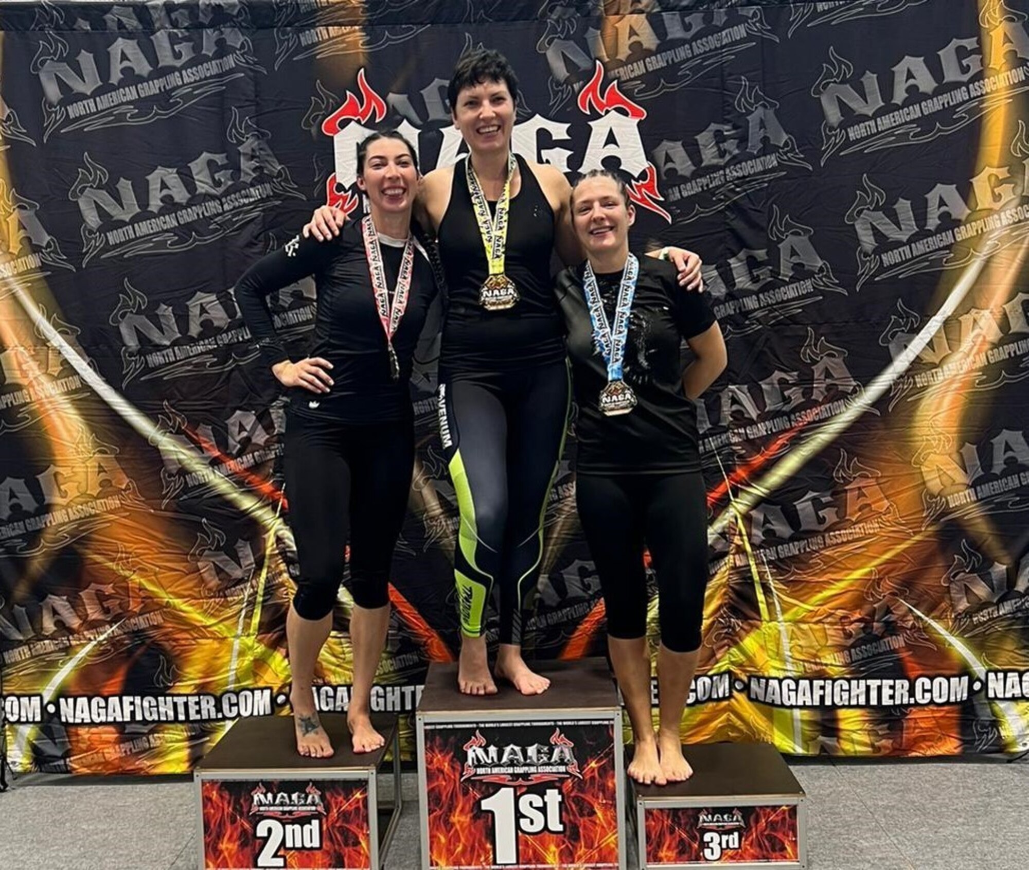 people stand on pedestal as they are awarded medals