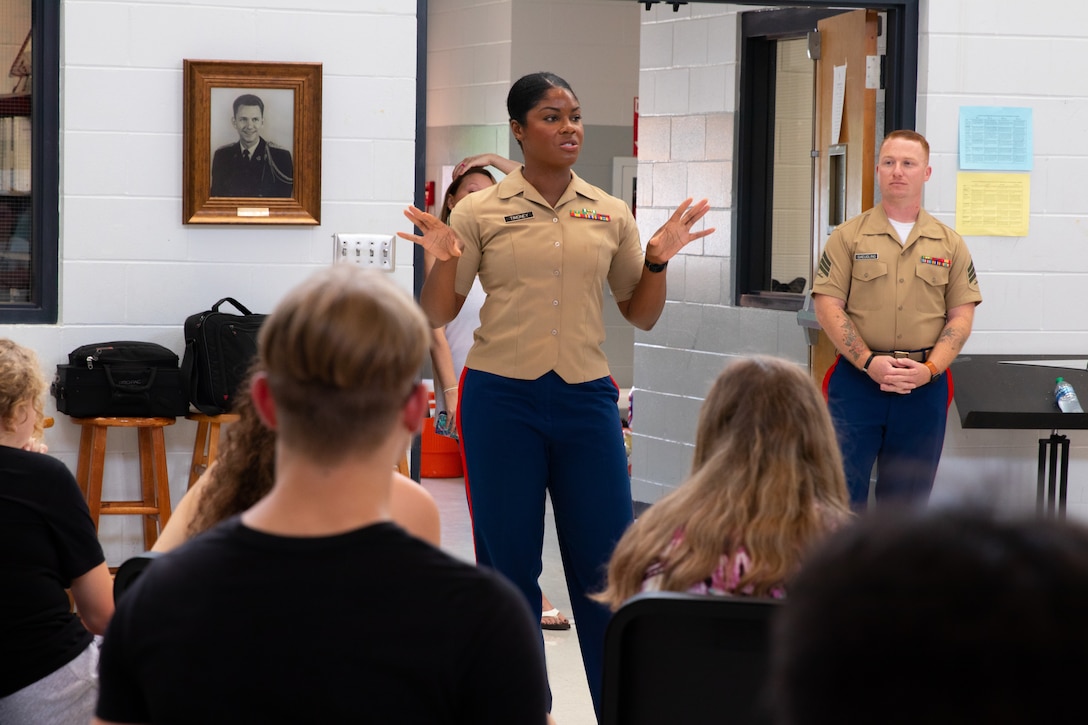 U.S. Marine Corps Staff Sgt. Mardia Timoney, the Musician Technical Assistant for 6th Marine Corps District, speaks to band students at Fayette County High School in Fayette, Alabama, July 25, 2022. Timoney spoke with the students about what being a Marine musician is like and how they can audition to become one. (U.S. Marine Corps photo by Sgt. Shannon Doherty)