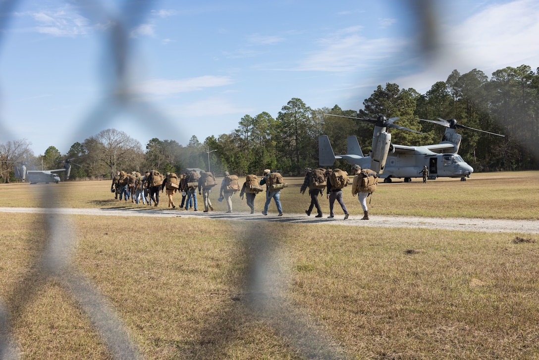 U.S. Marine Corps role players board a MV-22 Osprey aircraft assigned to Marine Medium Tiltrotor Squadron 162 (Reinforced), 26th Marine Expeditionary Unit (MEU), following a simulated military assisted, Noncombatant Evacuation Operation (NEO) near Hinesville, Georgia, Dec. 17, 2022. NEO are the ordered or authorized departure of civilian noncombatants and nonessential military personnel from danger in an overseas country to a designated safe haven. The NEO was one of multiple scenario-based exercises conducted during Marine Expeditionary Exercise (MEUEX) I, in order to fulfill Pre-Deployment Training Program (PTP) requirements by training to MEU Mission Essential Tasks. (U.S. Marine Corps photo by Capt. Angelica White)