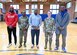 U.S. Air Force Col. Catherine "Cat" Logan and Command Chief Master Sgt. Clifford Lawton, Joint Base Anacostia-Bolling and 11th Wing commander and command chief Chief Master Sgt. Clifford Lawton pose for a group photo with members of the Extreme Football League D.C. Defenders team at the JBAB fitness center on Dec. 16, 2022, JBAB, Washington, D.C. Engagements with sports teams in the greater D.C. area are one of many ways JBAB connects with the surrounding communities. Strong community partnerships foster trust and support, bridging the military-civilian gap in experience and understanding. (U.S. Air Force photo by Tech. Sgt. Kayla White)