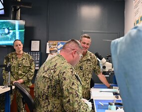 Rear Adm. Pete Garvin, right, commander, Naval Education and Training Command (NETC), speaks with Sailors assigned to Surface Combat Systems Training Command Middle Pacific detachment, at Joint Base Pearl Harbor-Hickam, Hawaii, as part of a visit to Hawaii area NETC commands, Dec. 15, 2022. NETC's mission is to recruit, train and deliver those who serve our nation, taking them from street-to-fleet by transforming civilians into highly skilled, operational and combat ready warfighters. (U.S. Navy photo by Joanne Tumacder)