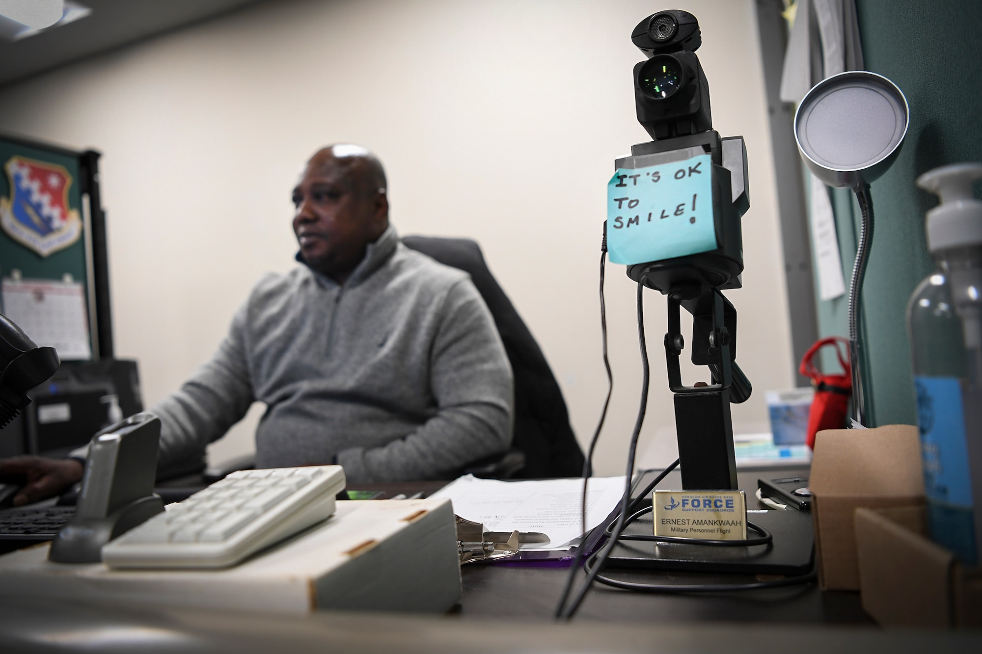 Ernest Amankwaah, 66th Force Support Squadron Military Personnel Flight customer service technician, reviews documents and trainings at his desk at Hanscom Air Force Base, Mass., Dec. 15. Amankwaah immigrated to the U.S. from Ghana in 1999 after being selected for a permanent resident visa through the Diversity Immigration Visa Program. (U.S. Air Force photo by Lauren Russell)