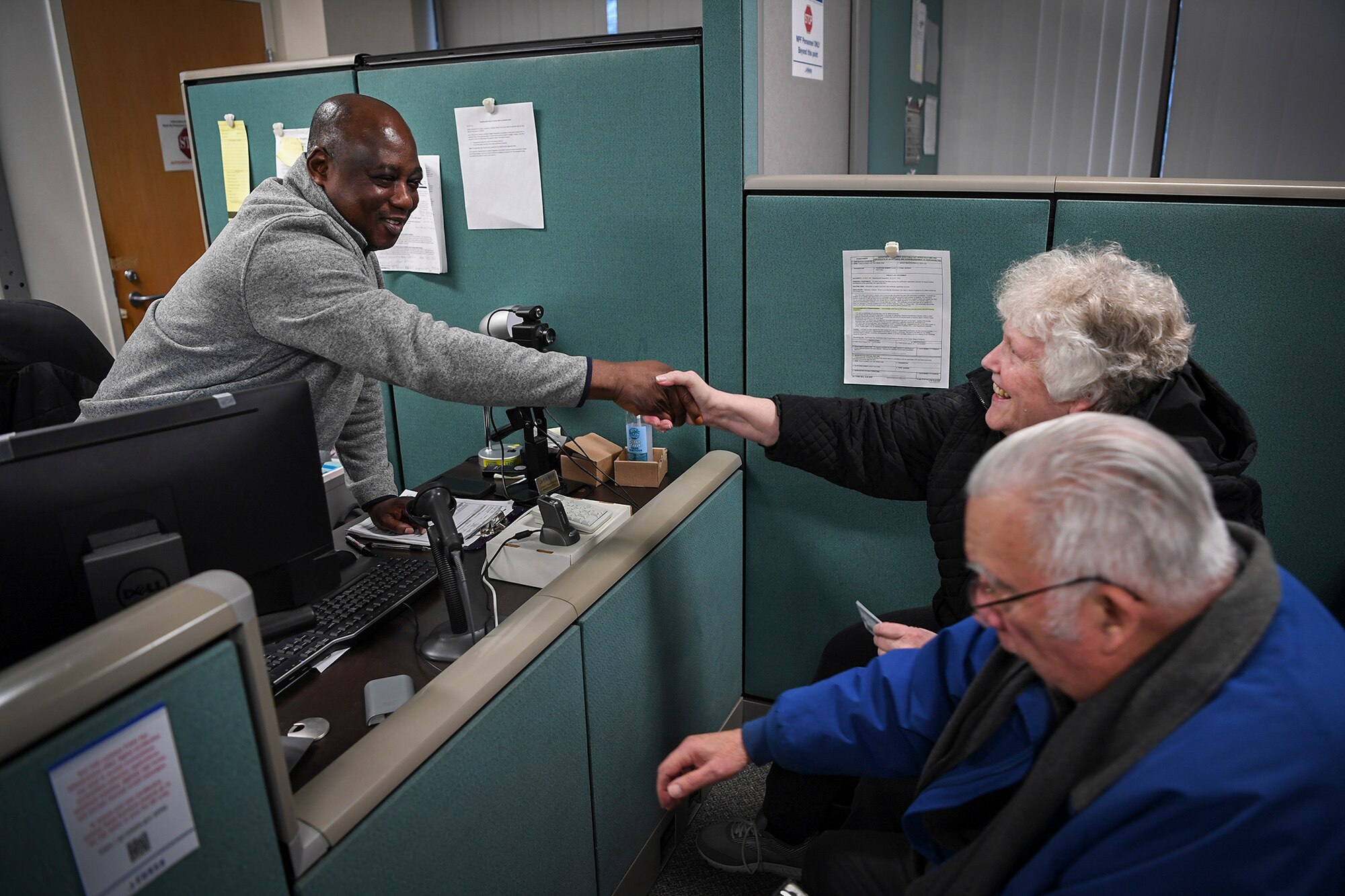 Ernest assists the couple across from him, shakes Martha's hand