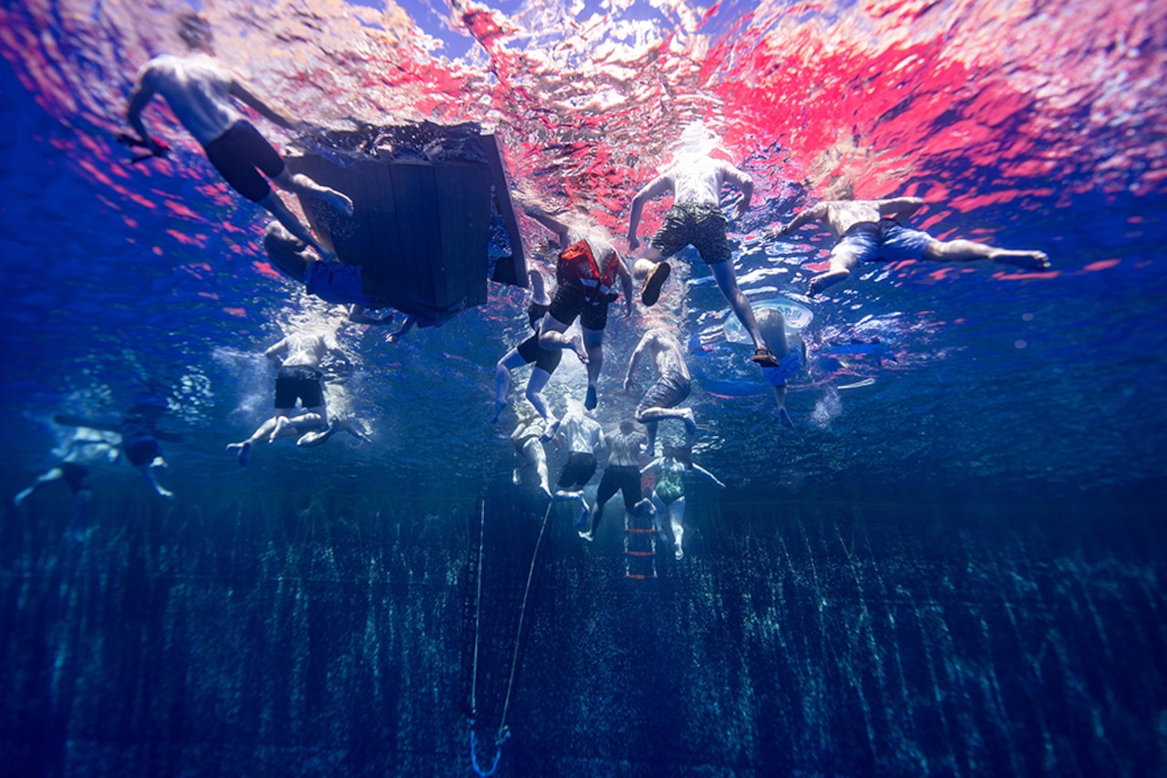 Coast Guardsmen enjoy a swim in the Pacific Ocean.