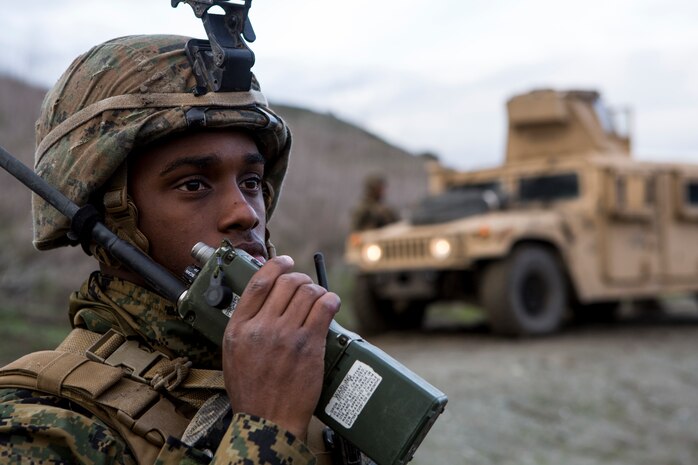 U.S. Marine Corps Sgt. Demarcus Tunstall, a motor transport operator assigned to I Marine Expeditionary Force Support Battalion, speaks into an AN/PRC-152 Multiband Handheld Radio to communicate with the vehicle commanders during convoy training at Marine Corps Base Camp Pendleton, Calif., Jan. 16, 2019. I MSB conducted convoy training through a simulated hostile area to improve the unit's ability to accomplish its mission.