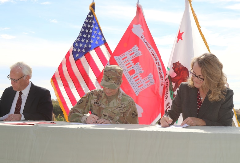 From left to right, G. Patrick O’Dowd, executive director, Salton Sea Authority; Col. Julie Balten, commander of the Corps’ LA District; and Cindy Messer, chief deputy director, California Department of Water Resources, sign a cost-share agreement for the Imperial Streams Salton Sea Feasibility Study during a Dec. 16 signing ceremony near the shores of the Salton Sea in Mecca, California.