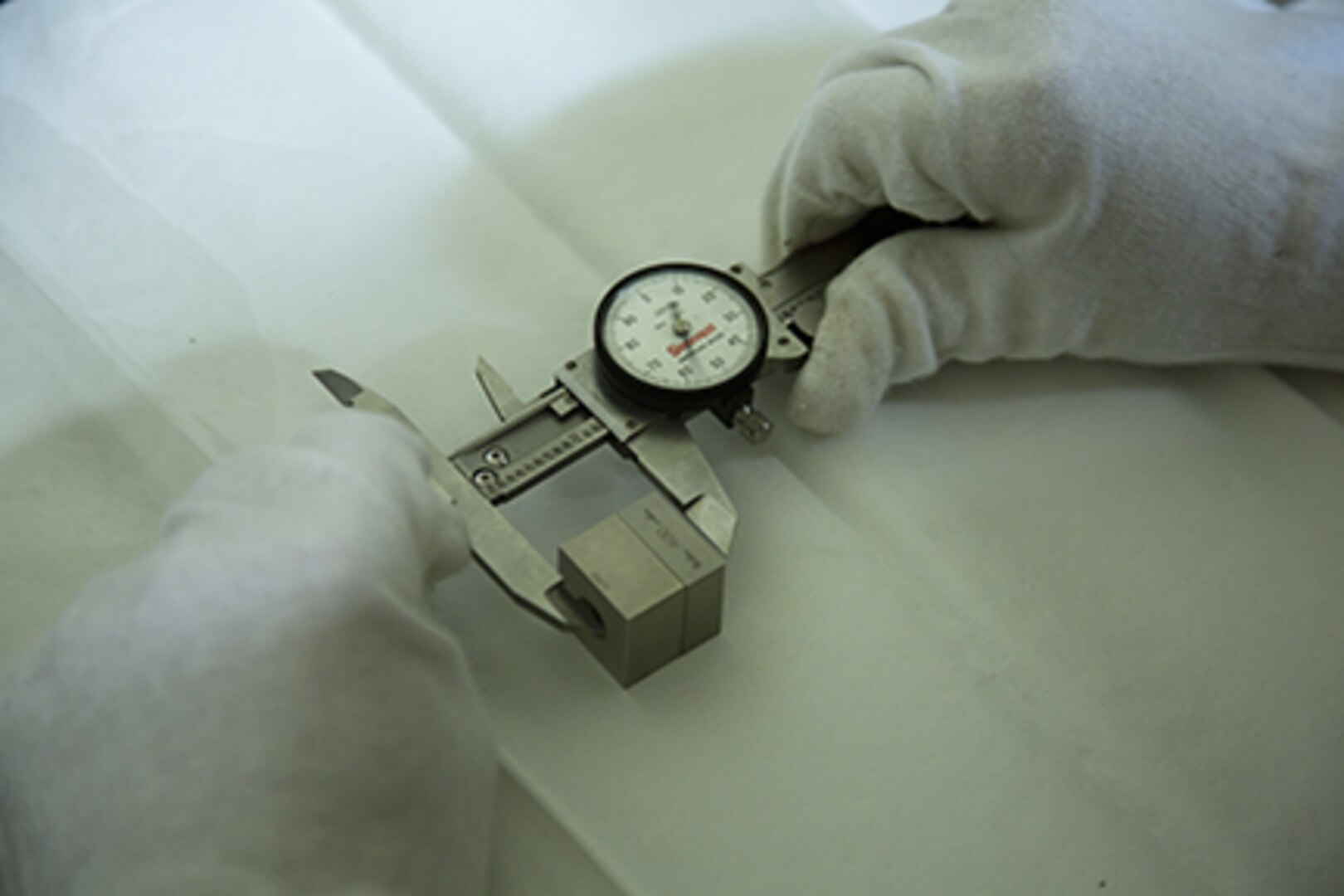 Pfc. Nathaniel Geelhoed tests a dial caliper’s accuracy July 23, 2018 at Camp Kinser, Okinawa, Japan