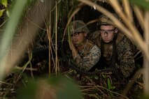 U.S. Marine Corps Cpl. Samuel Llamas, a combat engineer, and Lance Cpl. Ivey Logan, a landing support specialist, both with 3rd Landing Support Battalion, Combat Logistics Regiment 3, 3rd Marine Logistics Group, set up an ambush with an M240B medium machine gun for a simulated convoy during exercise Winter Workhorse, at Central Training Area, Camp Hansen, Okinawa, Japan, Dec. 6, 2022. Winter Workhorse is an annual exercise for CLR-3 to train to carry out mission essential tasks in forward-deployed, austere environments. (U.S. Marine Corps photo by Lance Cpl. Weston Brown)