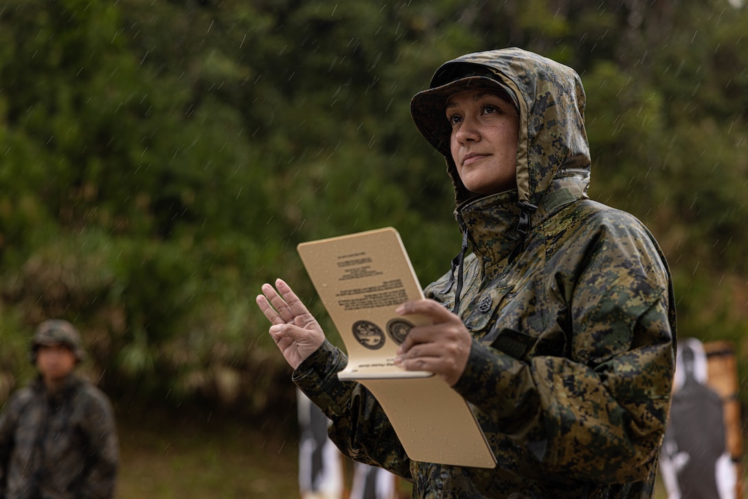 U.S. Marine Corps Staff Sgt. Stephanie Martinez, a supply operations chief with 3rd Sustainment Group (Experimental), 3rd Marine Logistics Group, reviews the safety rules for a rifle range during exercise Winter Workhorse, at Camp Hansen, Okinawa, Japan, Dec. 9, 2022. Winter Workhorse is an annual exercise for CLR-3 to train to carry out mission essential tasks in forward-deployed, austere environments. (U.S. Marine Corps photo by Lance Cpl. Weston Brown)