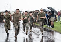 U.S. Marines with Combat Logistics Regiment 37, 3rd Marine Logistics Group, and personnel with the Japan Ground Self-Defense Force, compete in a relay race during a bilateral field meet on Camp Kinser, Okinawa, Japan, Dec. 9, 2022. CLR-37 conducted a bilateral field meet to celebrate the holiday season and boost morale with their JGSDF counterparts.
