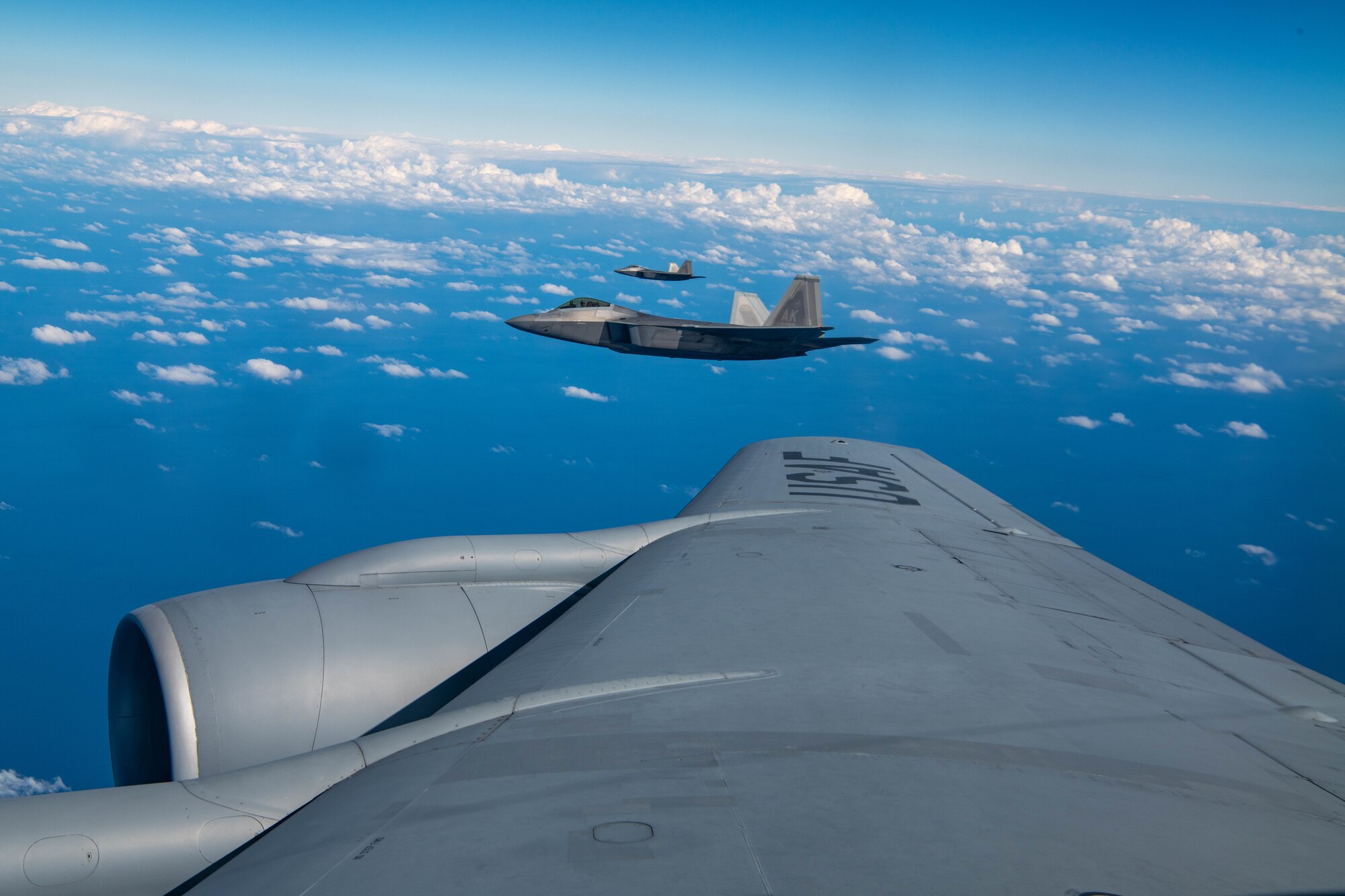 Aircraft fly in formation.