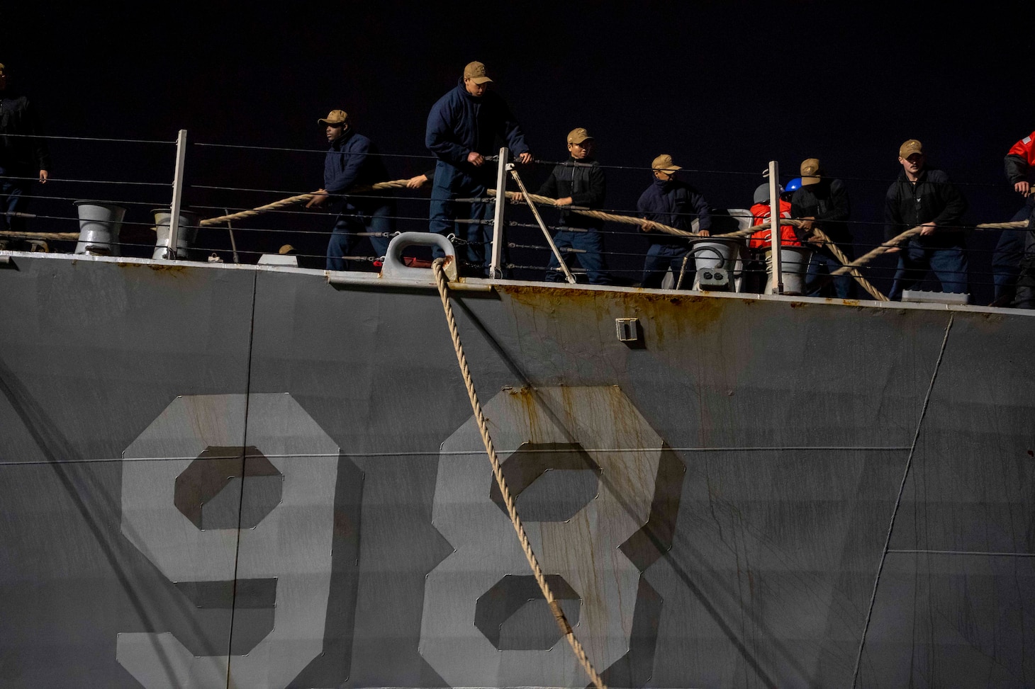 Sailors assigned to the Arleigh Burke-class guided-missile destroyer USS Forrest Sherman (DDG 98) heave in mooring lines as the ship returns to Naval Station Norfolk, Dec 22.