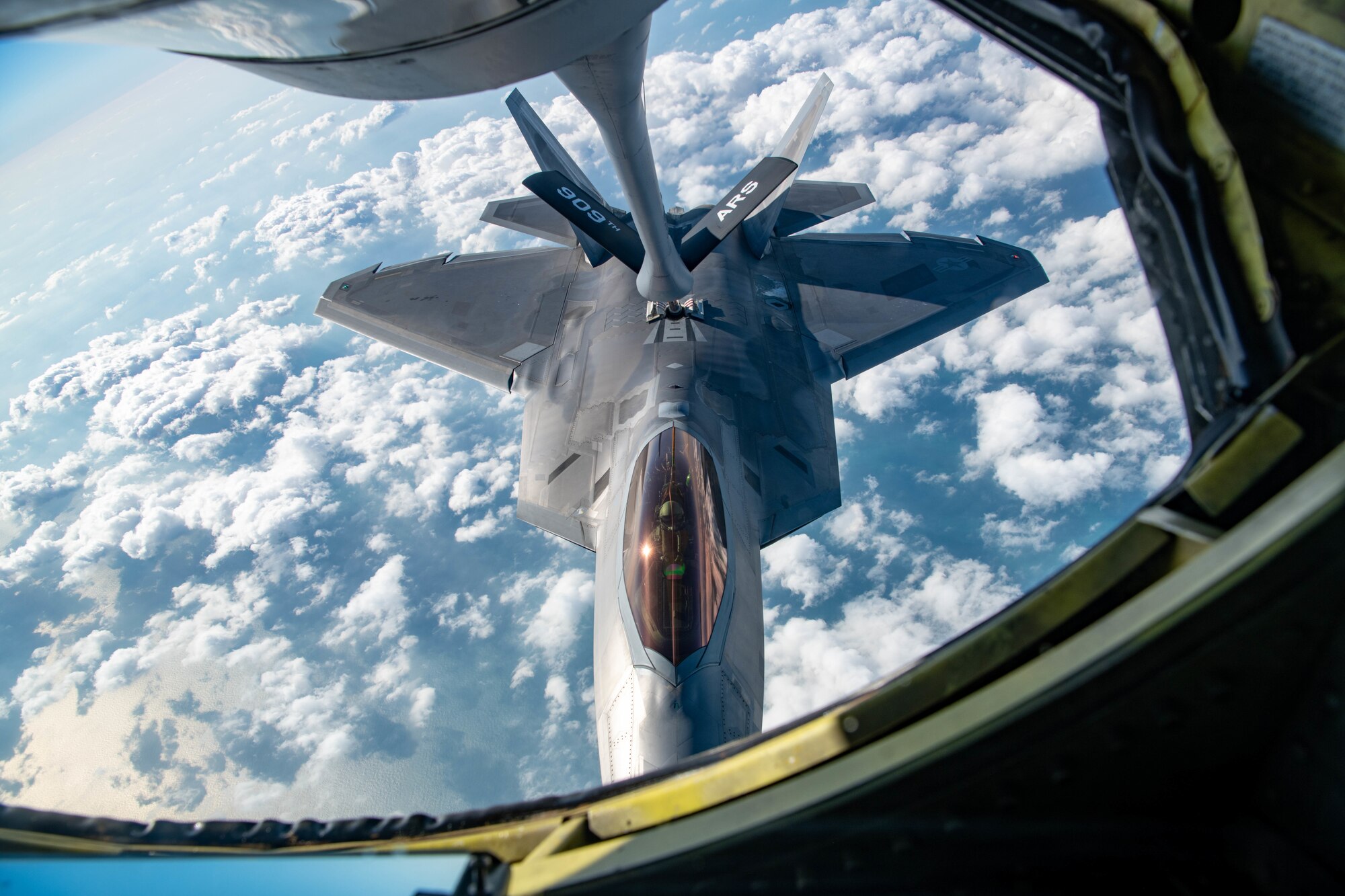 An aircraft receives fuel in air.