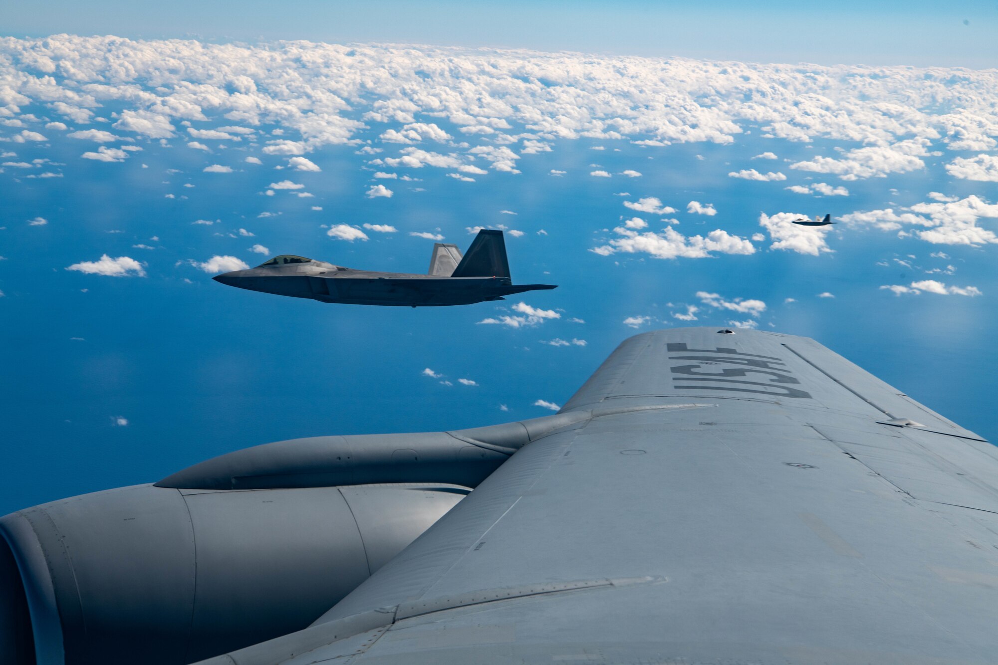 Aircraft fly in formation.