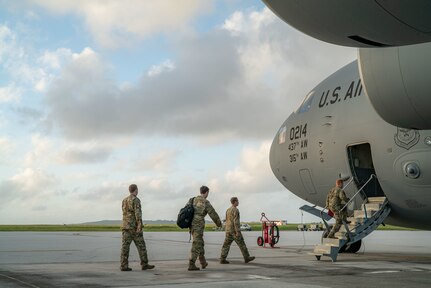A photo of Airmen walking to a C-17.