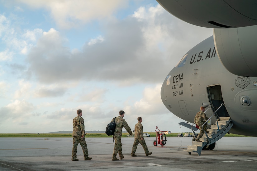A photo of Airmen walking to a C-17.