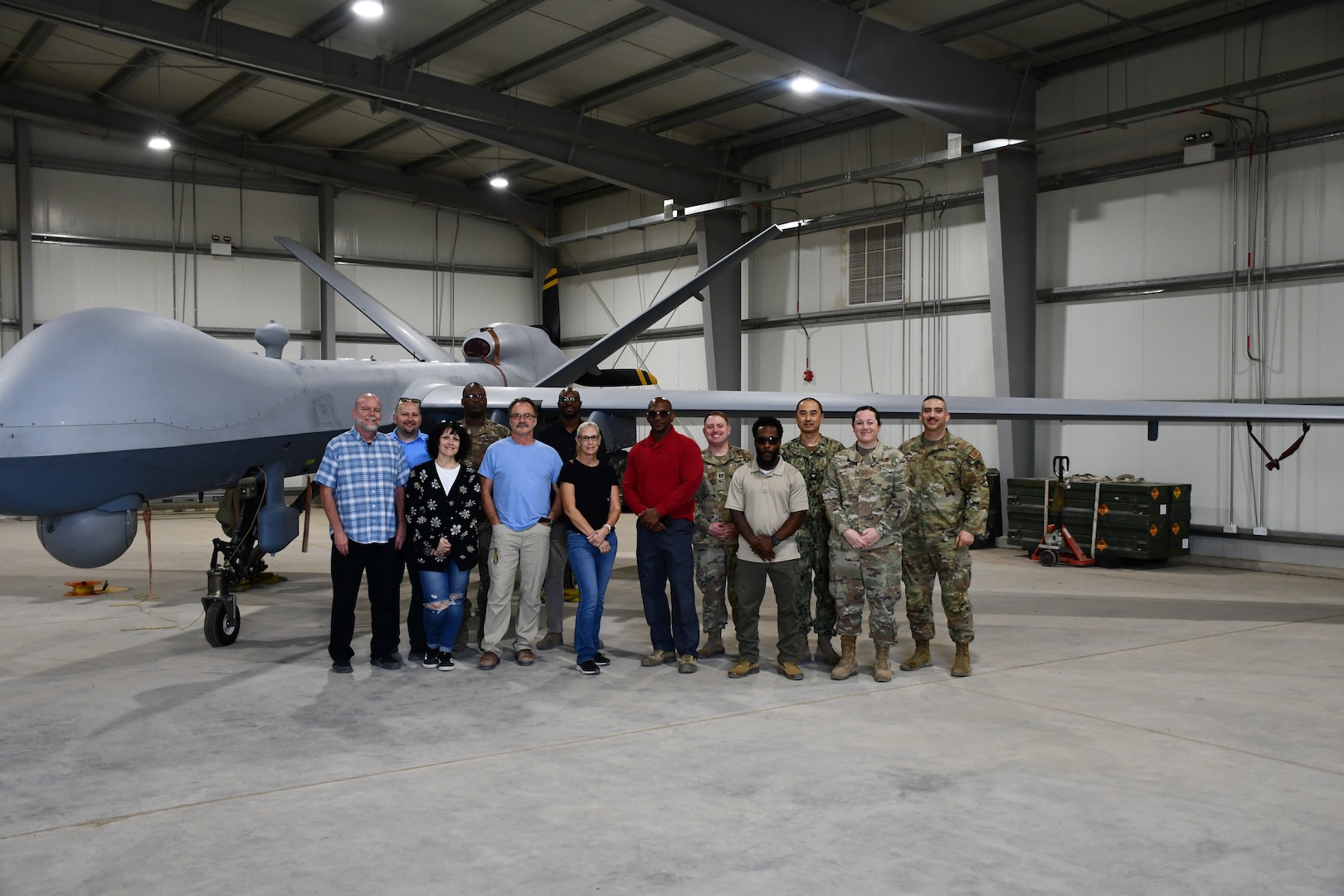 A group of employees pose in front of an airplane