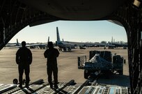 A photo of Airmen directing loading of a C-17.