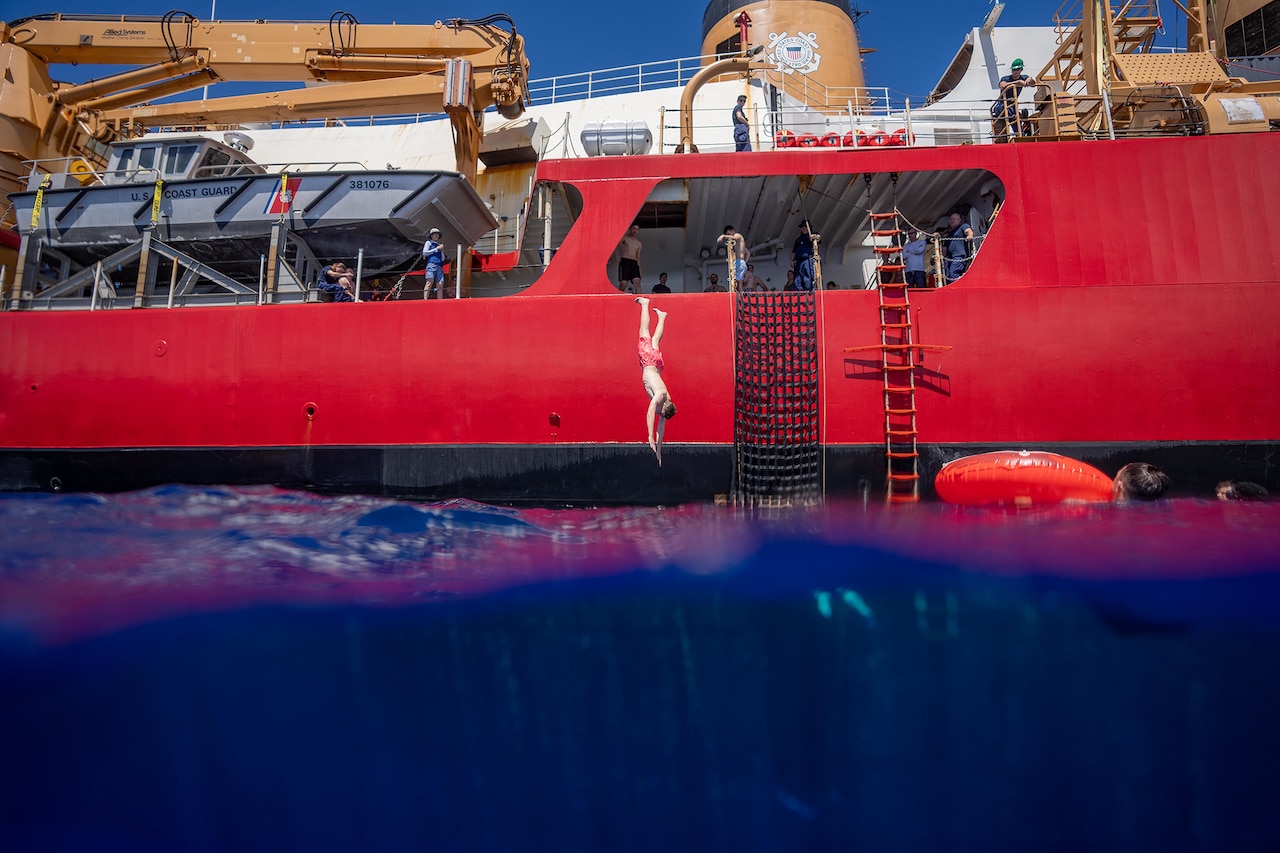 Coast Guardsmen enjoy a swim in the Pacific Ocean.