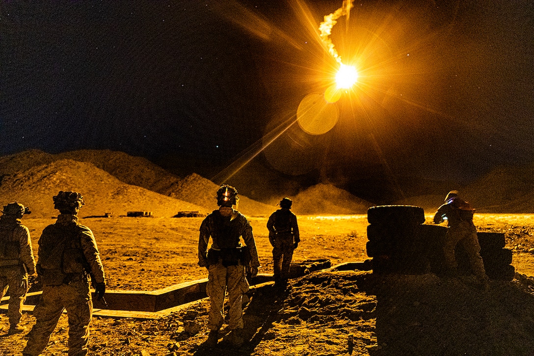 Marines participate in nighttime training in the desert.