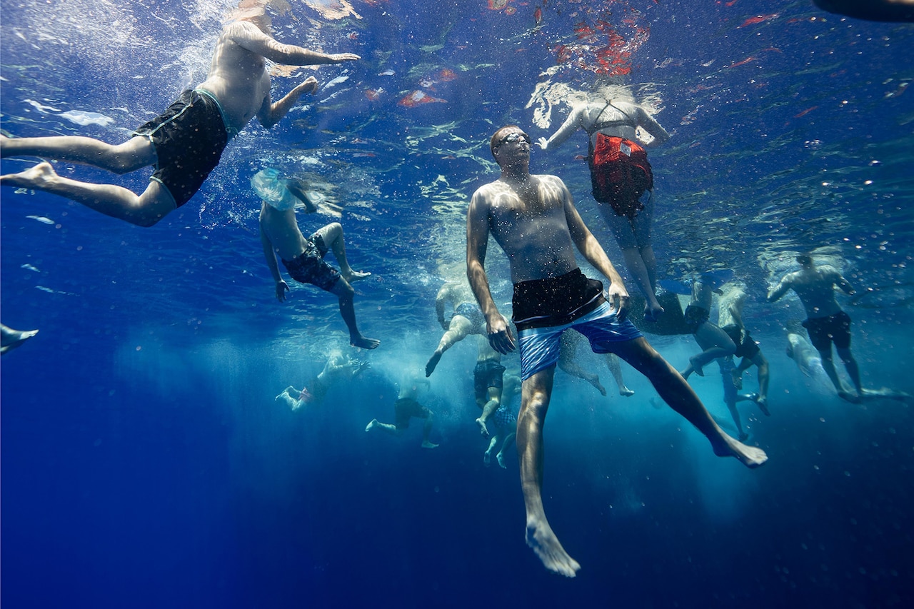 Coast Guardsmen enjoy a swim in the Pacific Ocean.